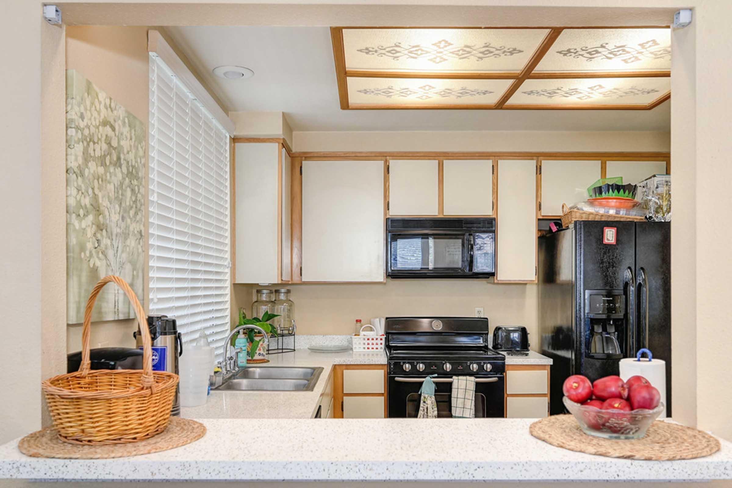 a bowl of apples on a kitchen counter