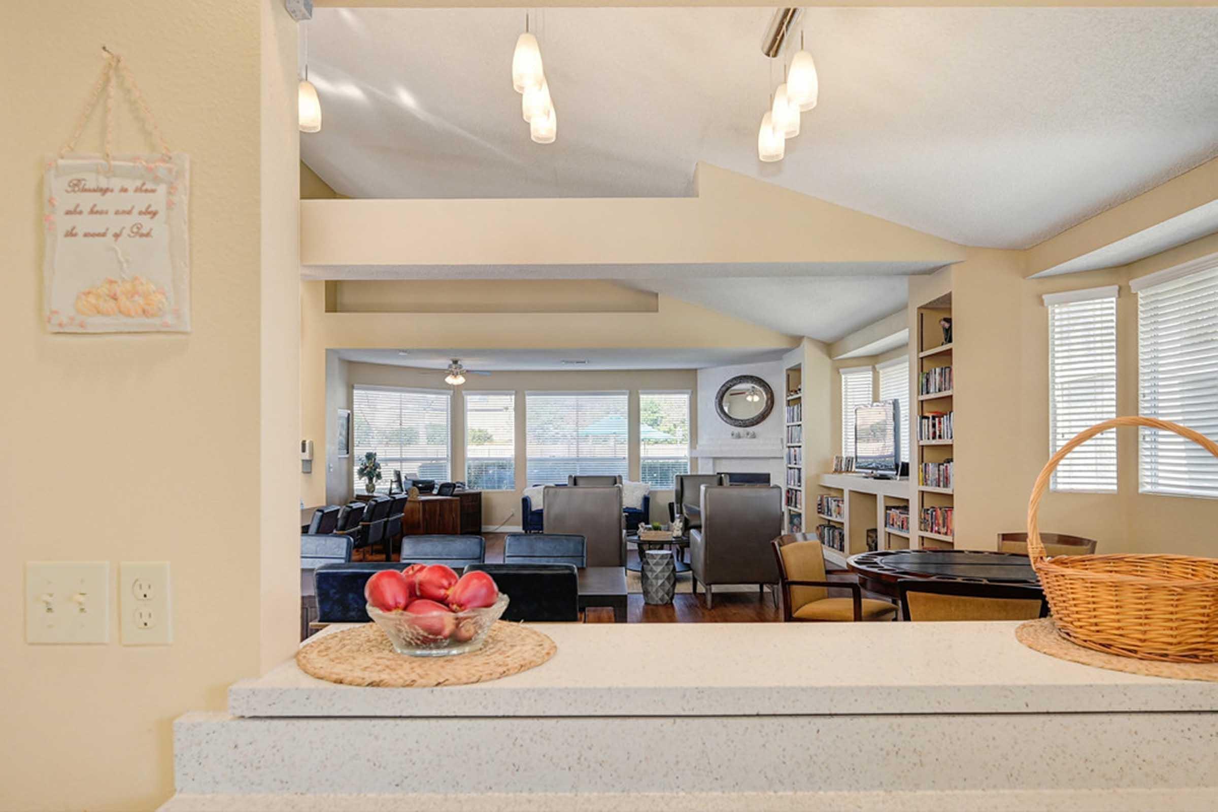 a counter with a bowl of apples