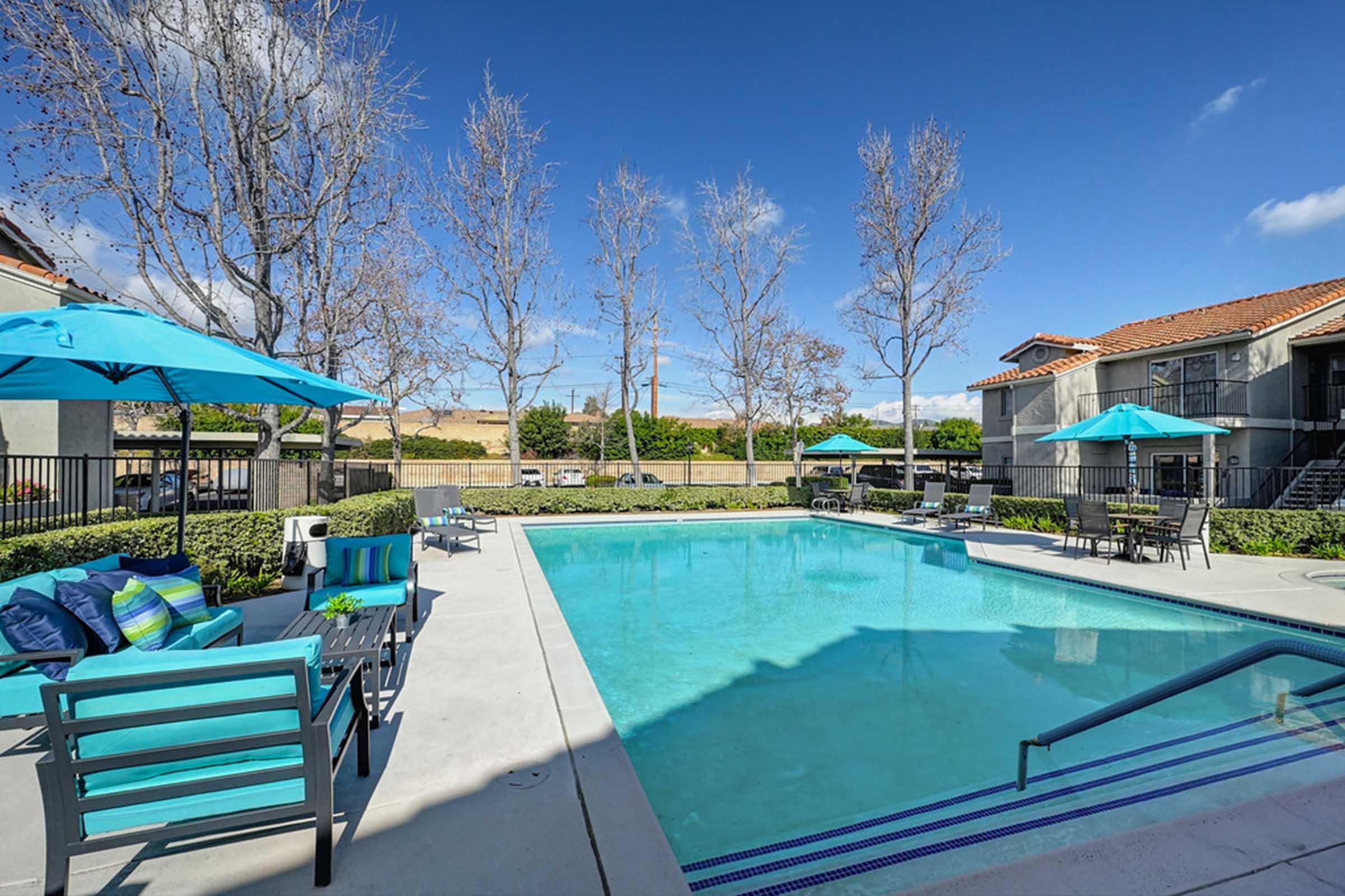 a pool next to lounge chairs