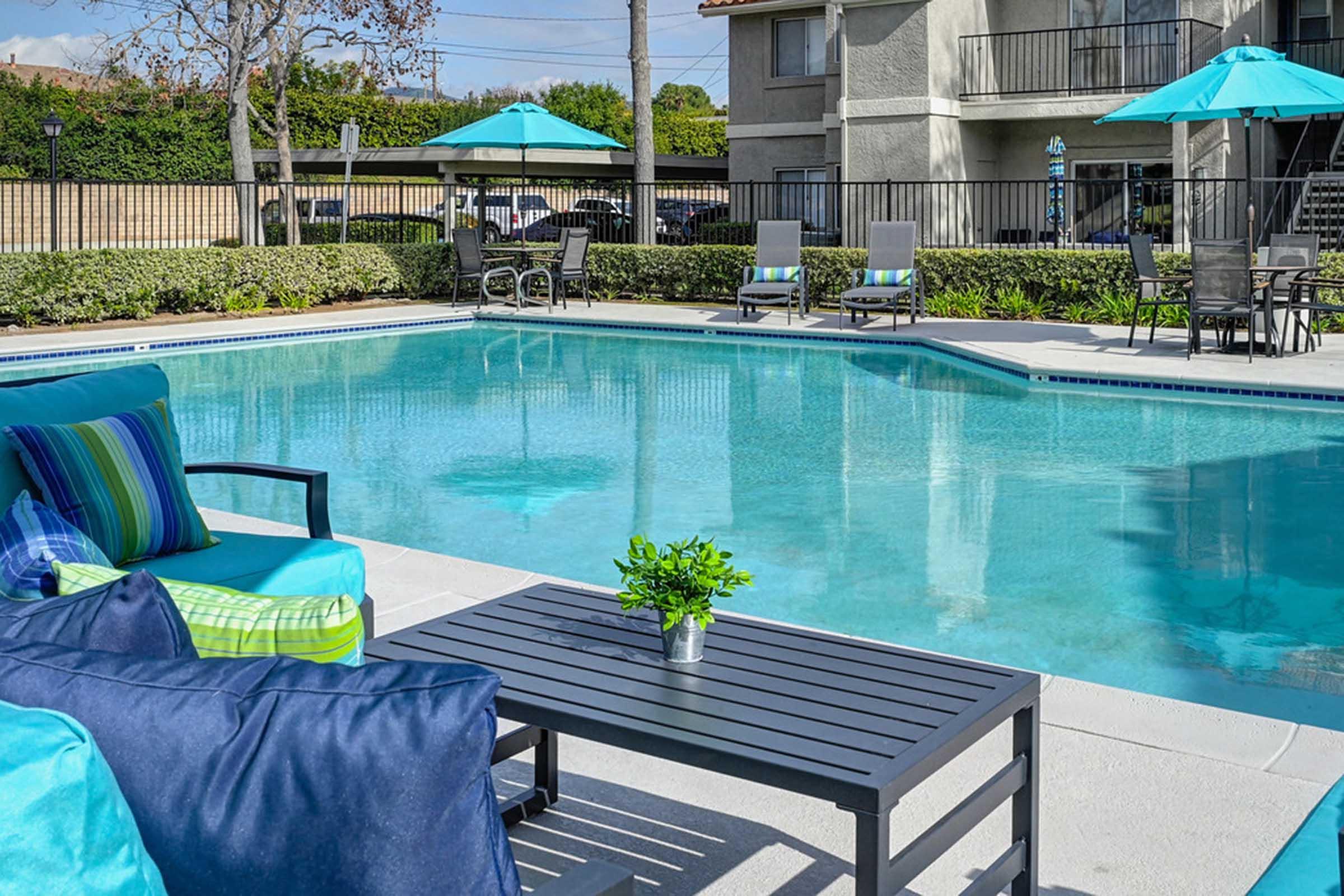 outdoor furniture next to a pool