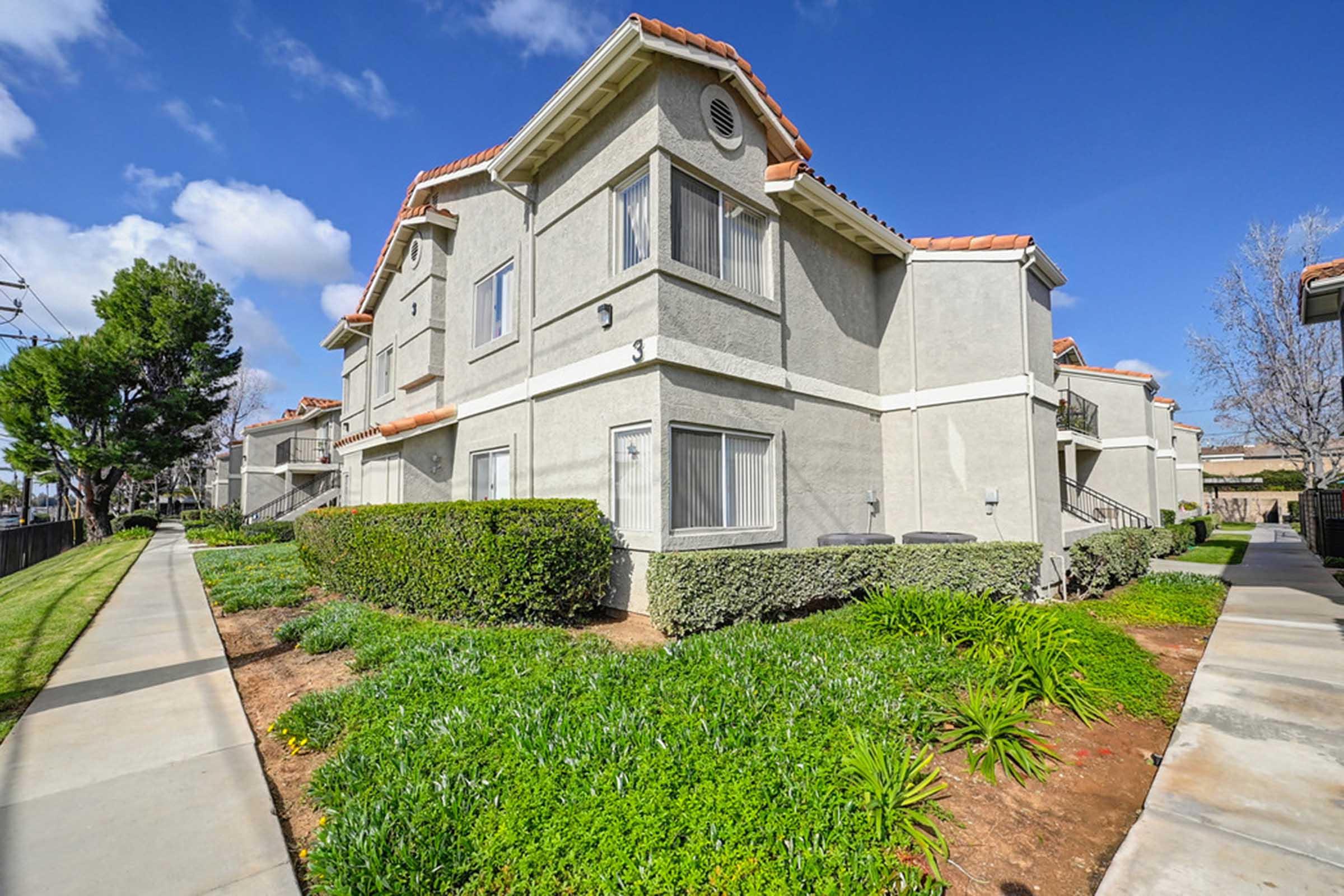 a large building with grass and bushes