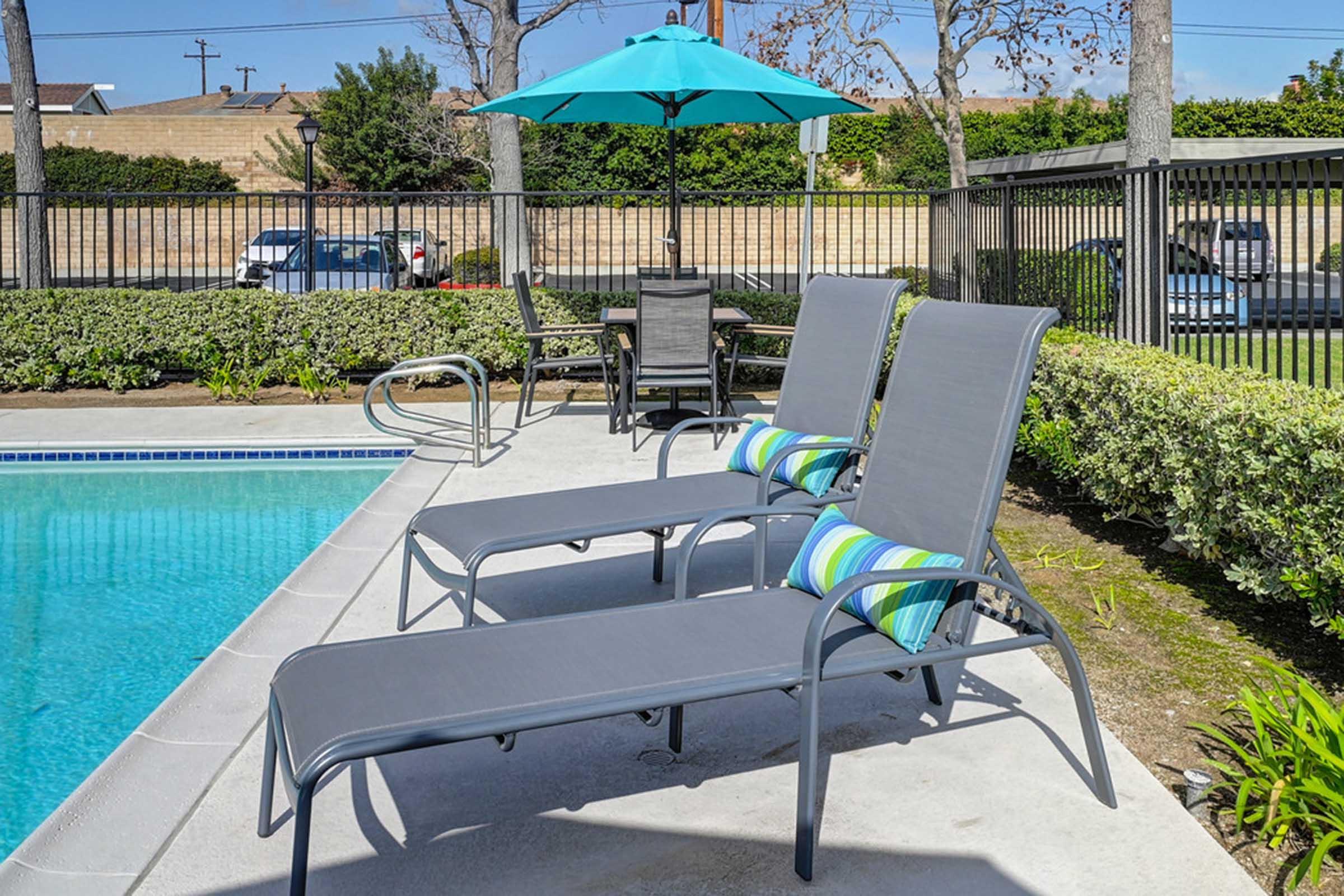 a couple of chairs sitting next to a pool