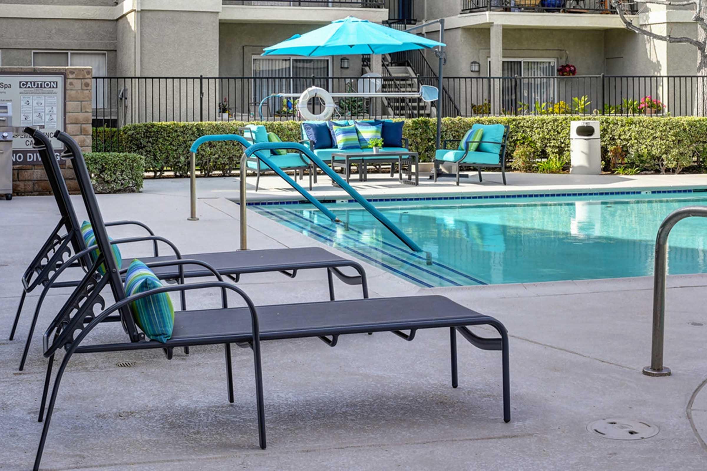 a chair sitting in front of a blue pool