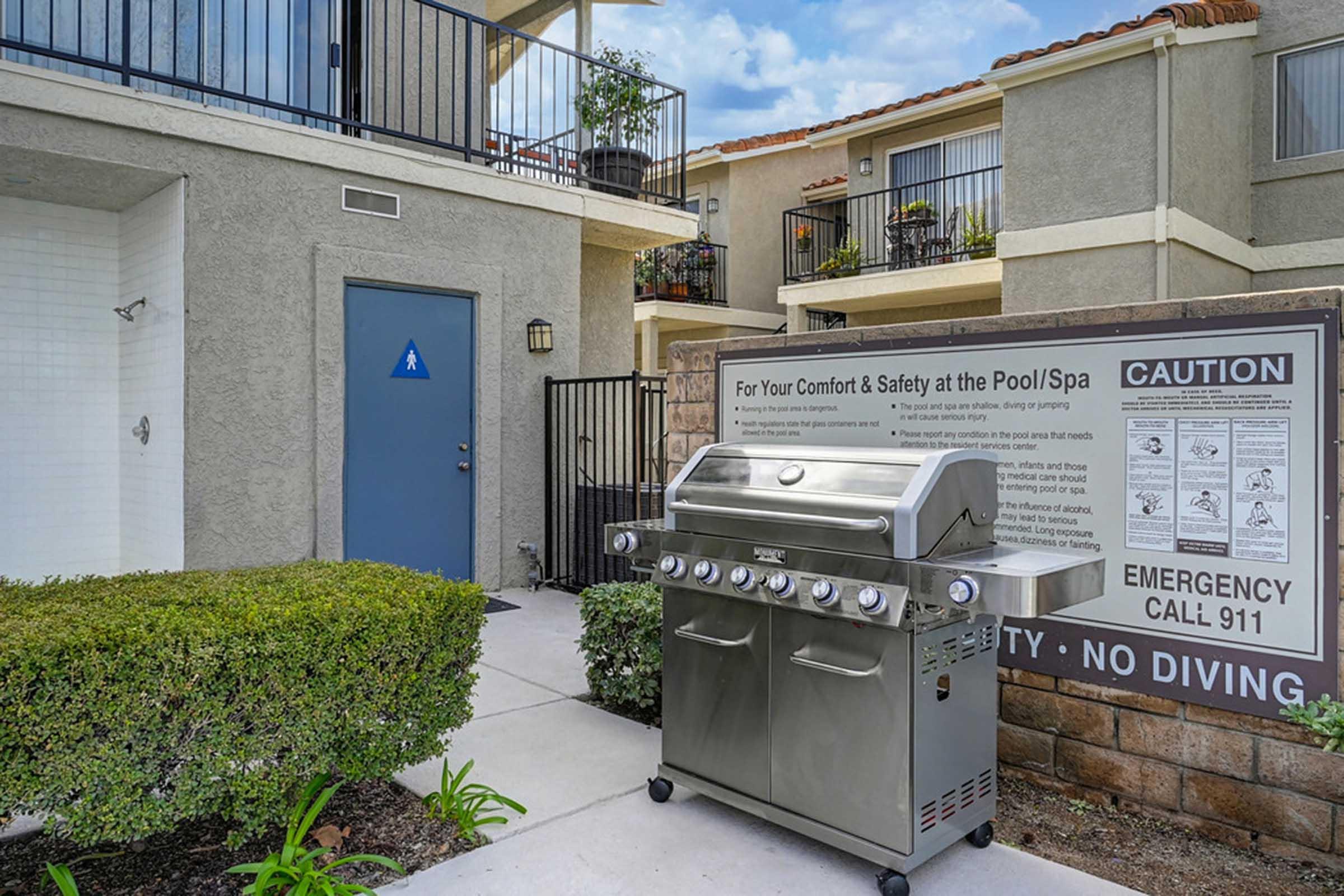 a barbecue next to a bush