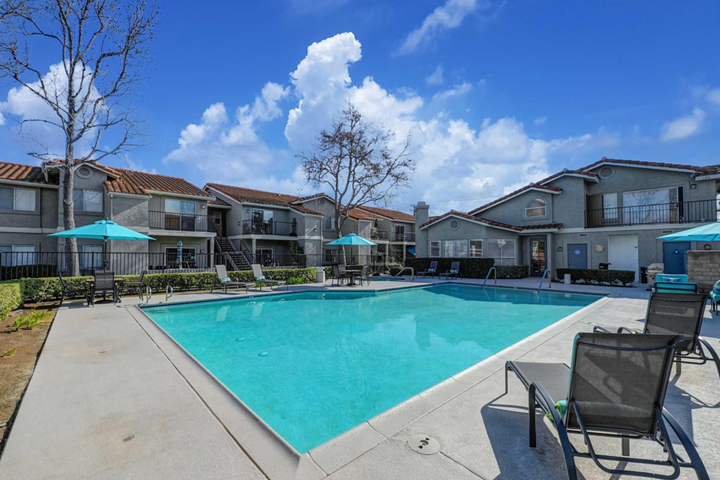 a pool with trees and buildings