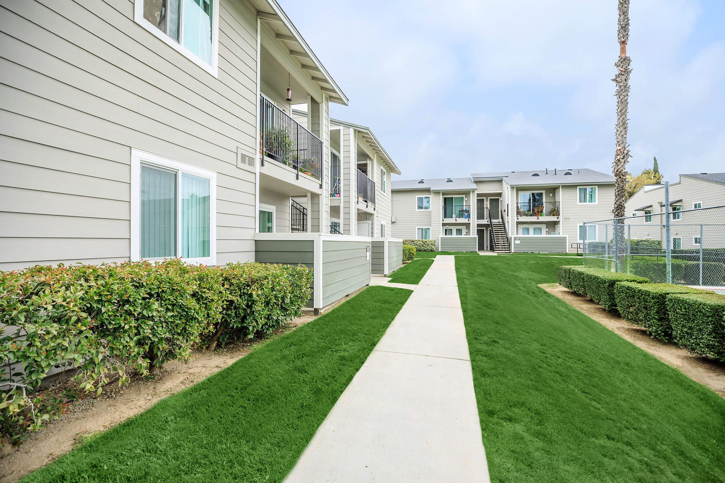 Orchard Park Apartments community building with green shrubs