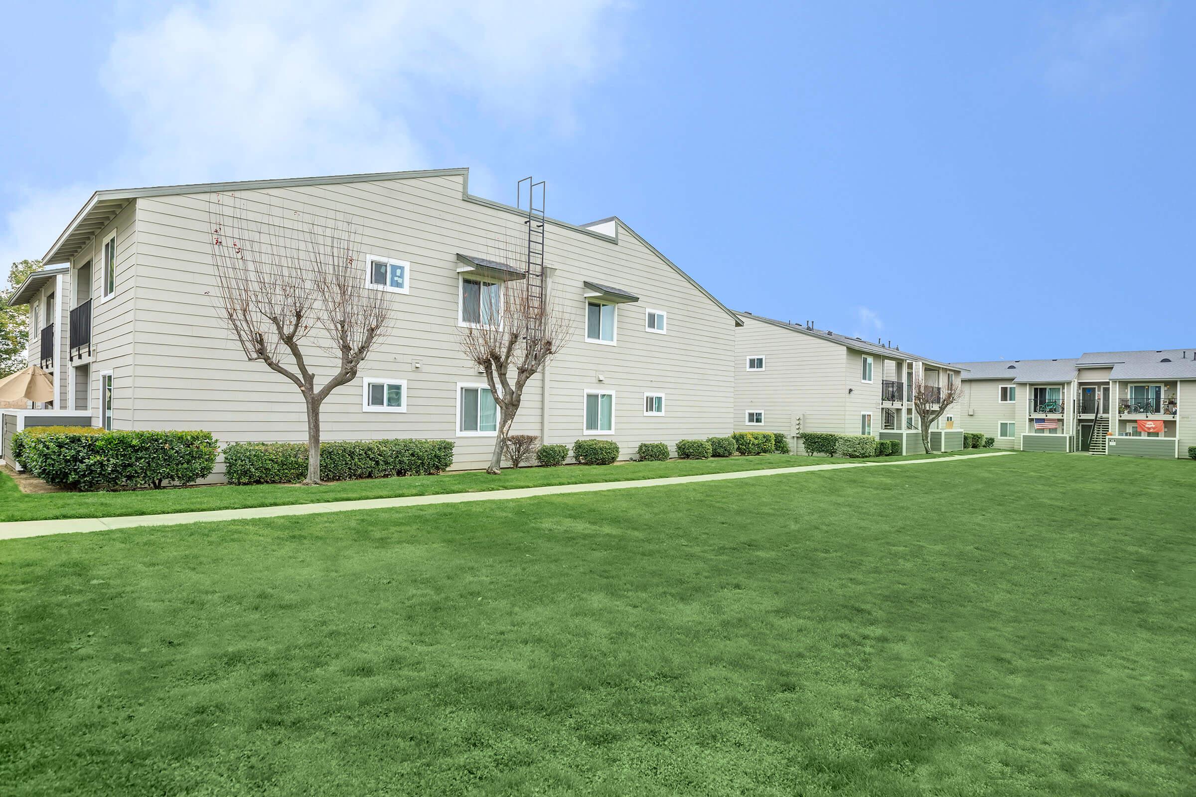 a building with a grassy field