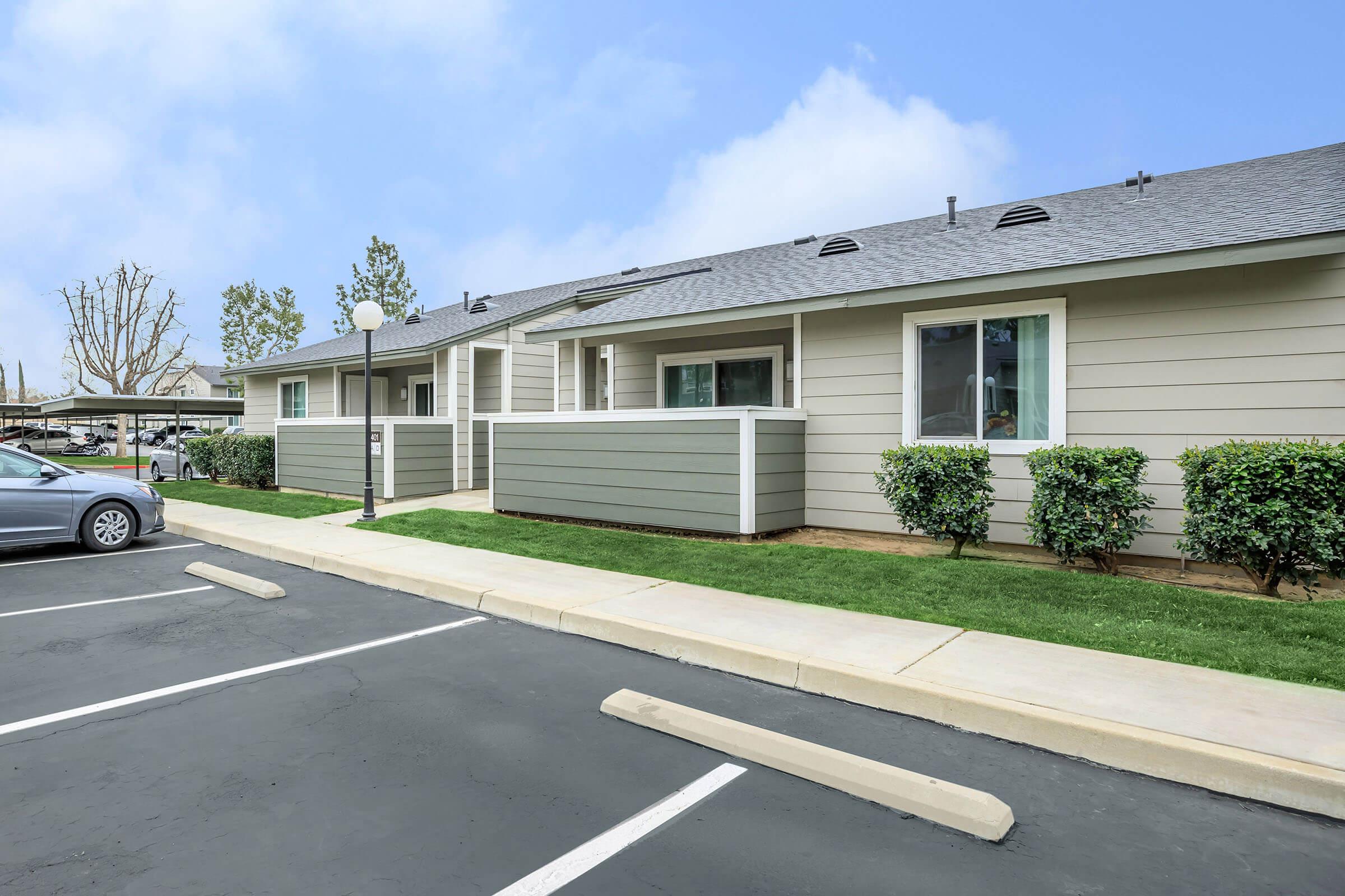 Orchard Park Apartments community building with green bushes