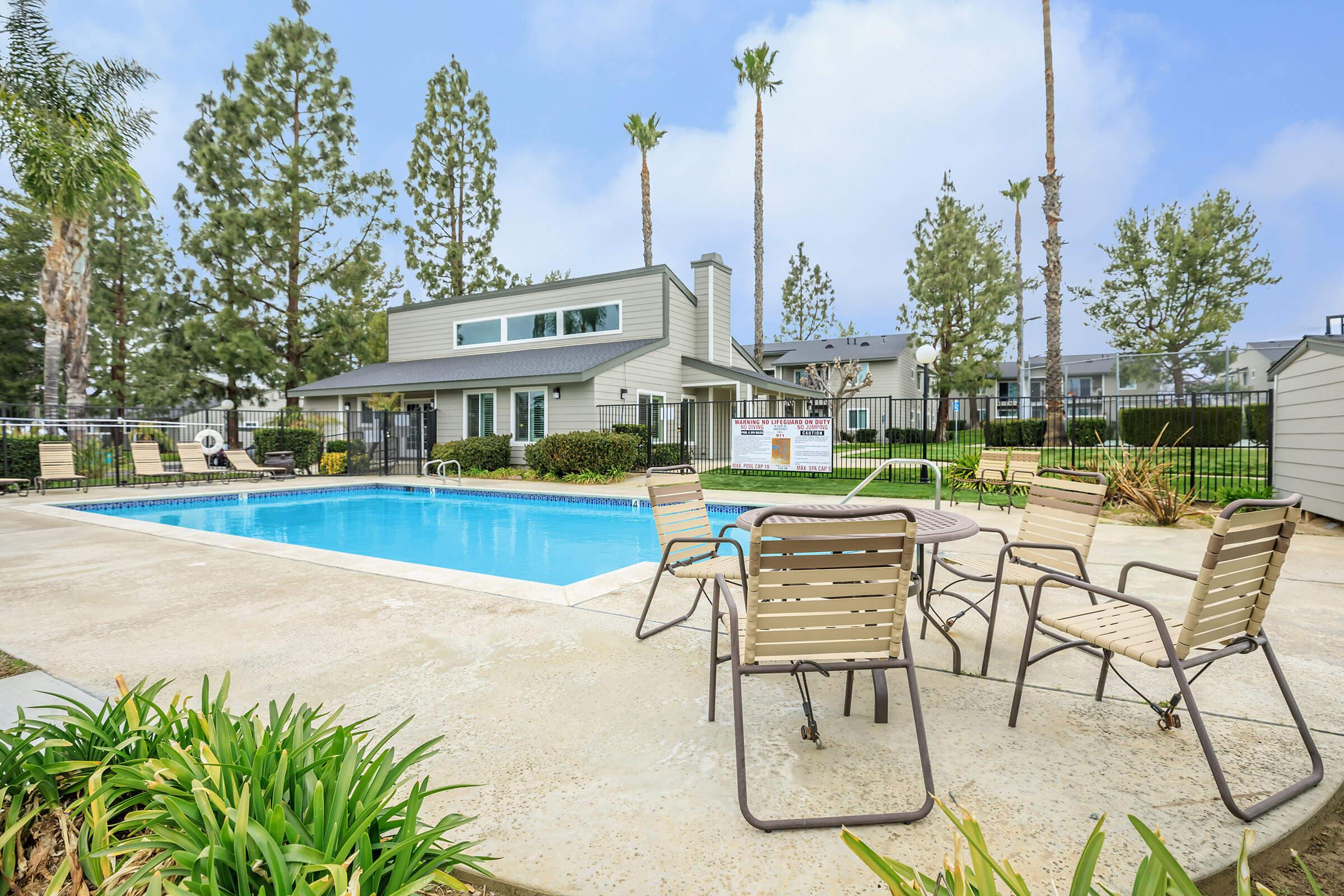 Orchard Park Apartments community pool with green trees