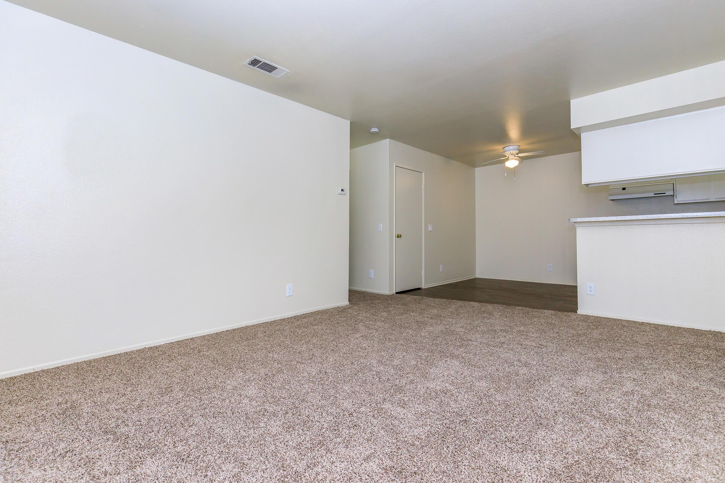 Vacant apartment with carpet and wooden floors