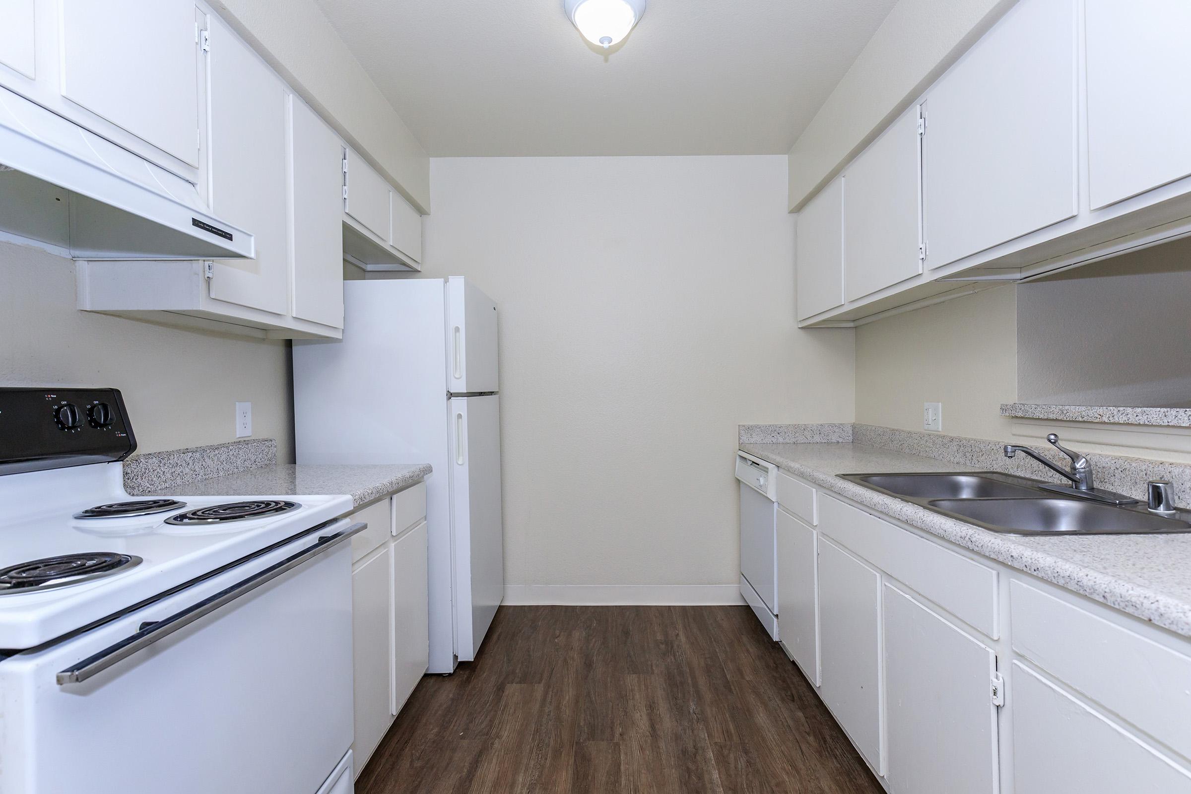 Vacant kitchen with white aplliances