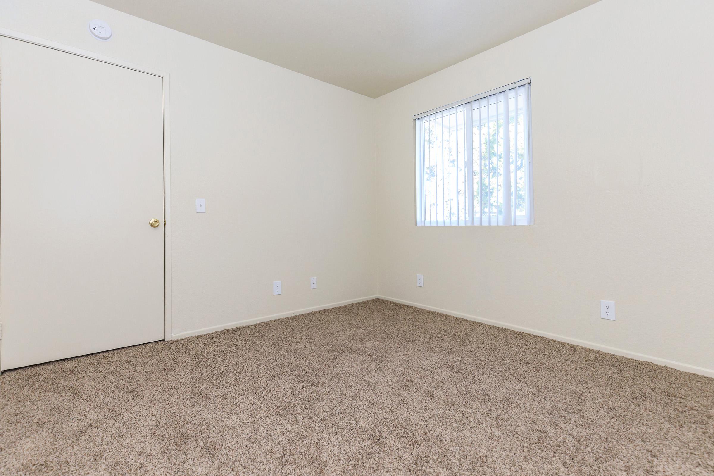 Unfurnished bedroom with carpet and a window