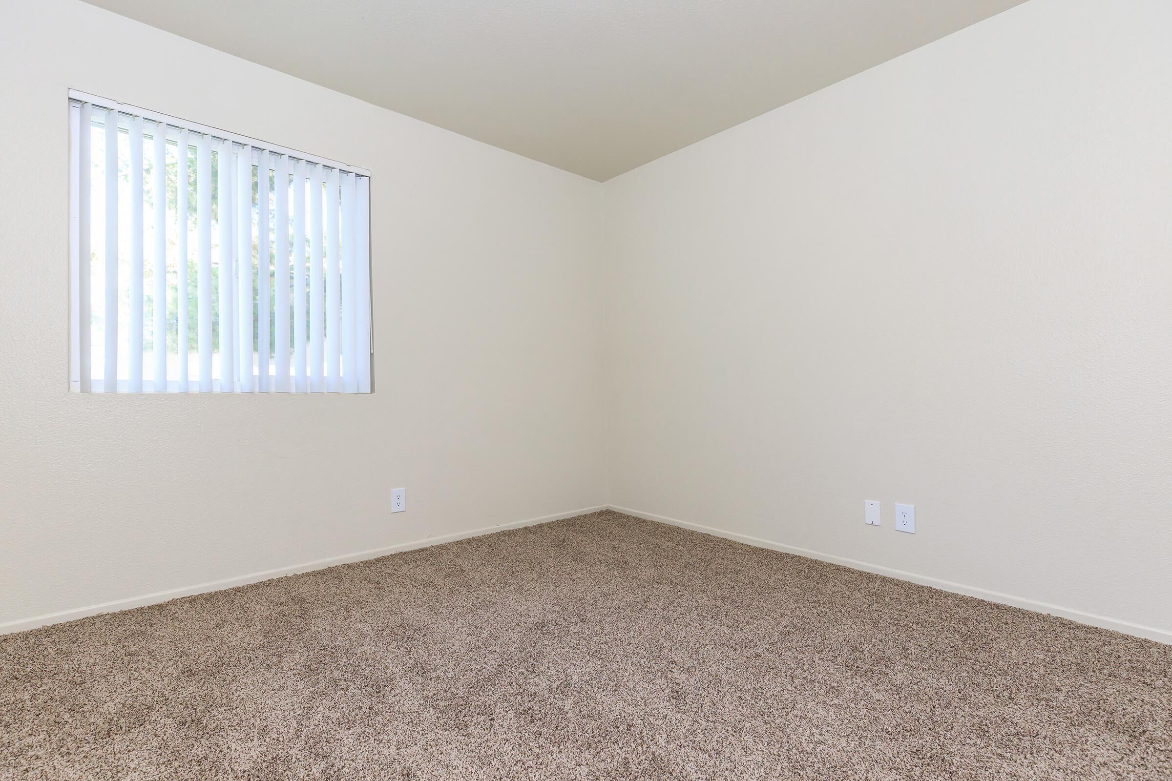 Carpeted unfurnished bedroom