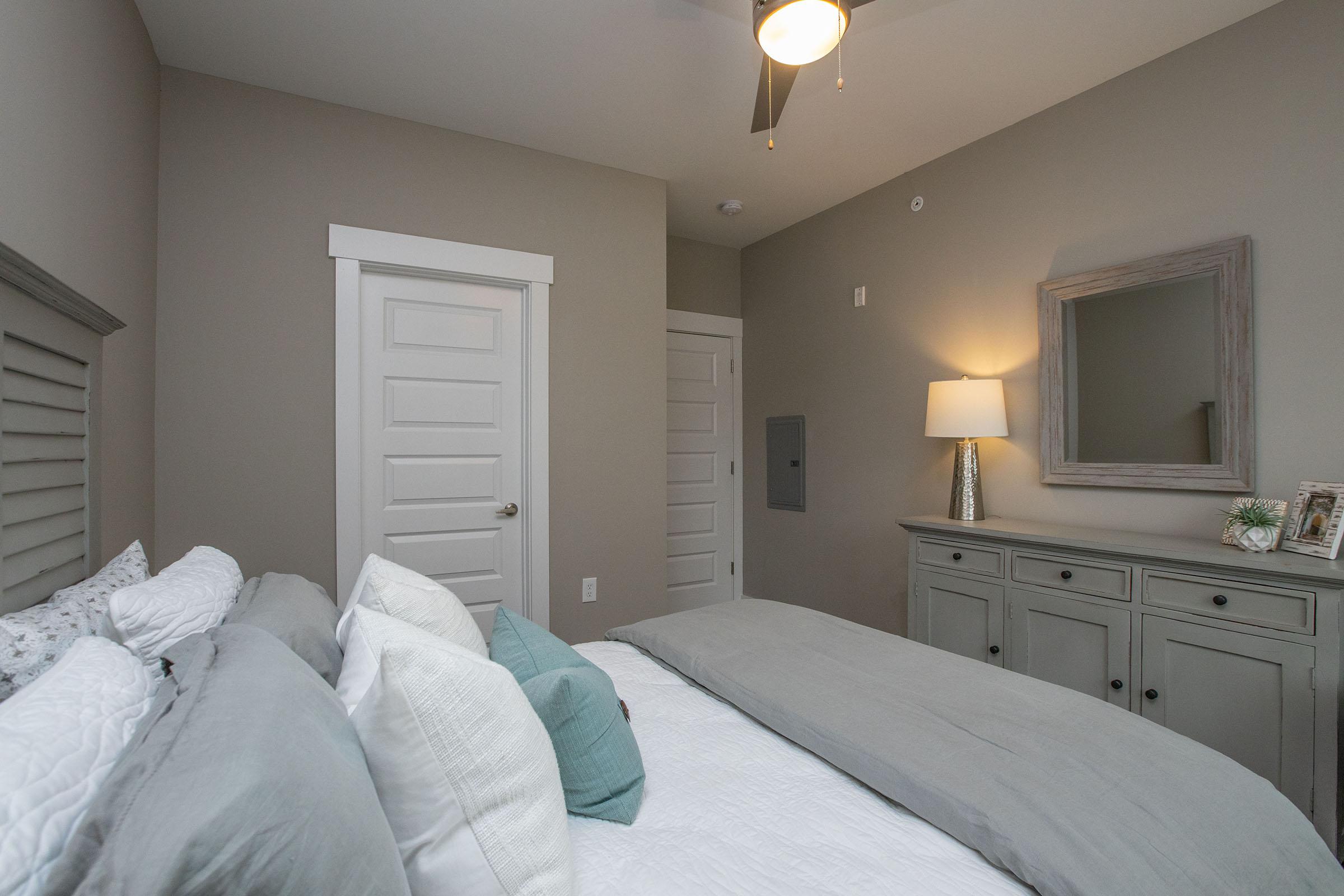 a bedroom with a bed and a mirror