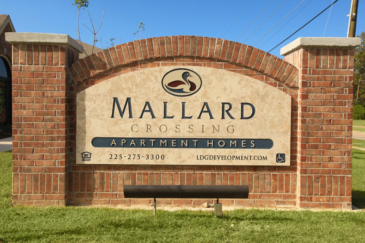 a sign in front of a brick building