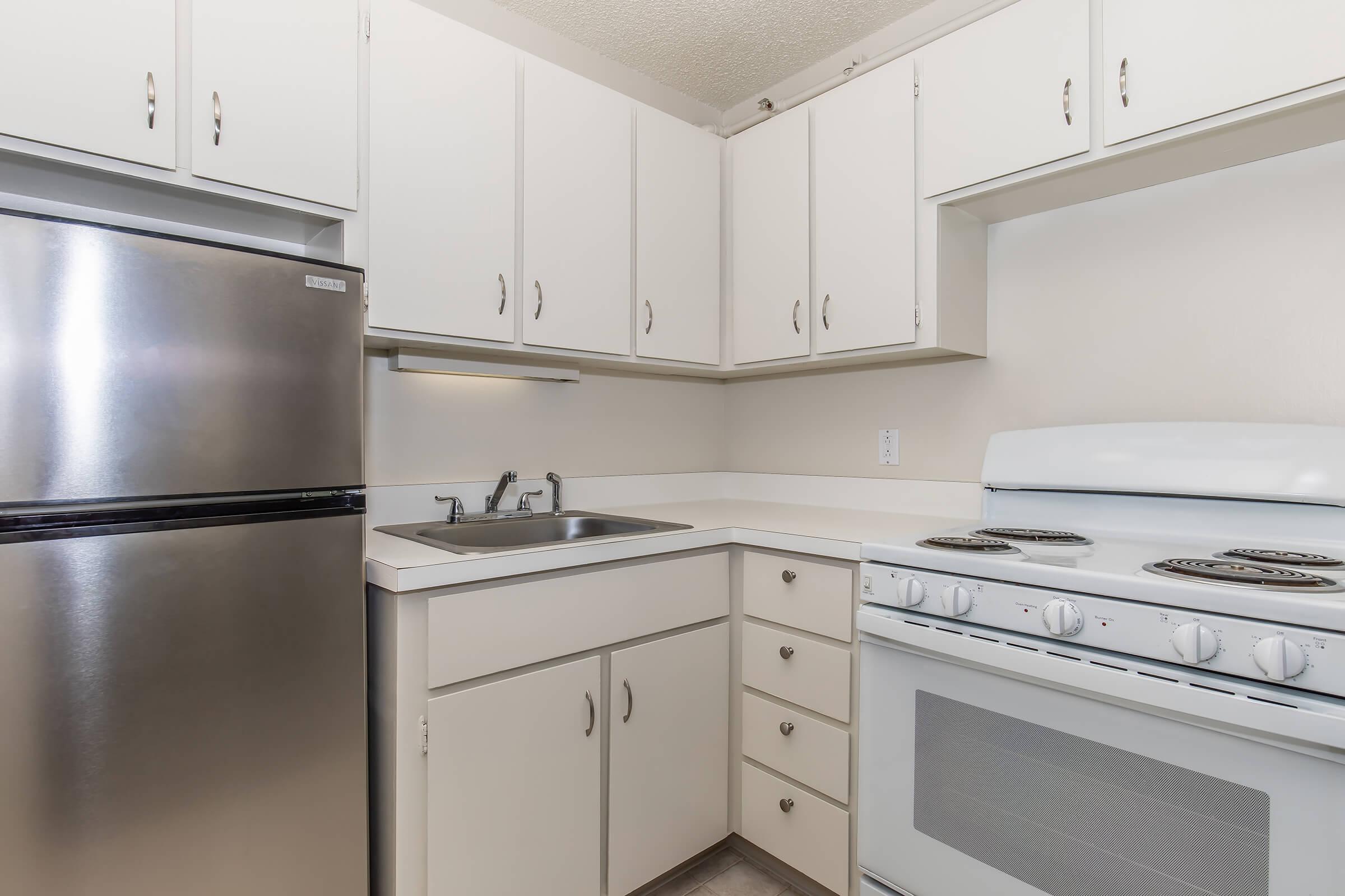 a stove top oven sitting inside of a kitchen