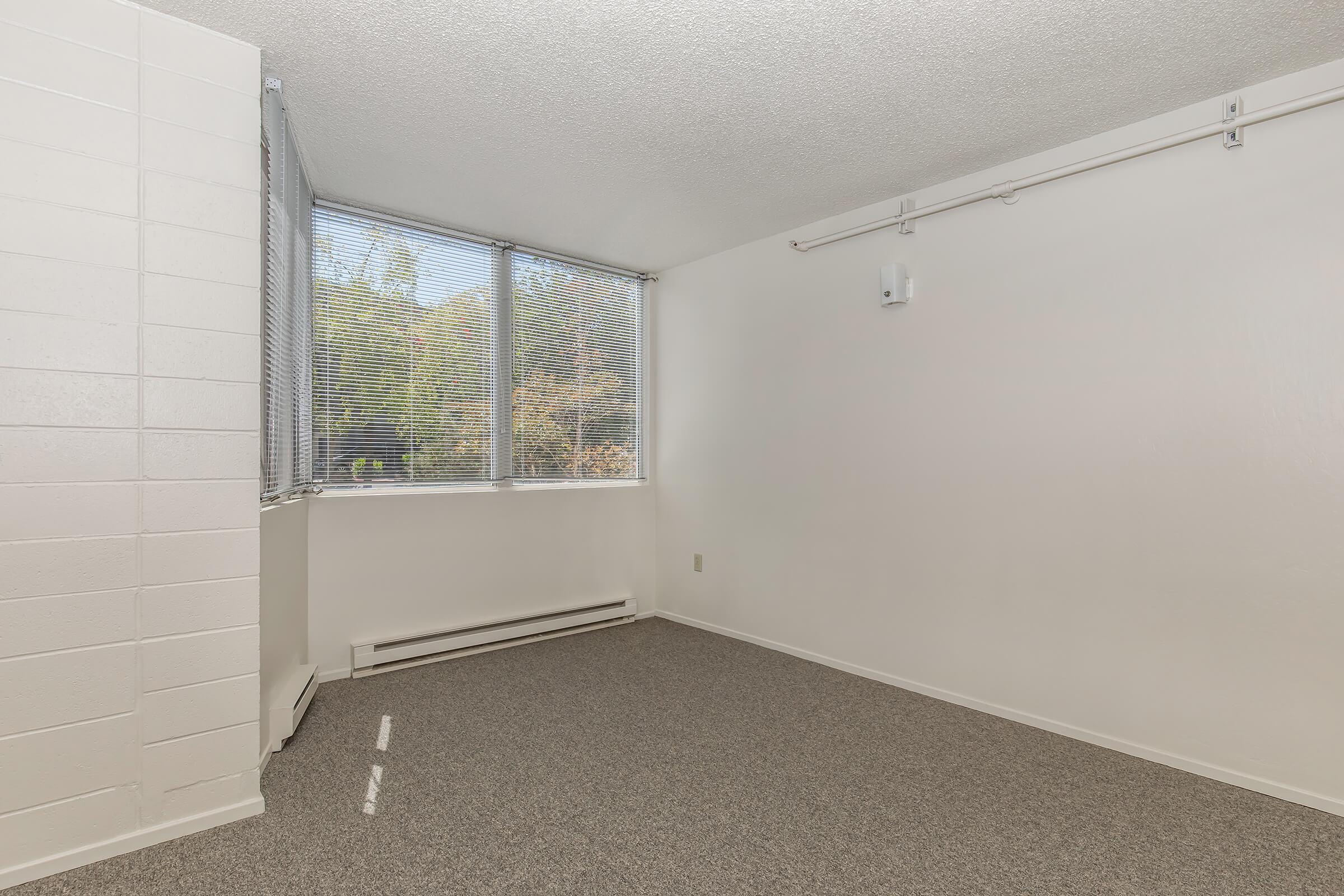 a bedroom with a large window