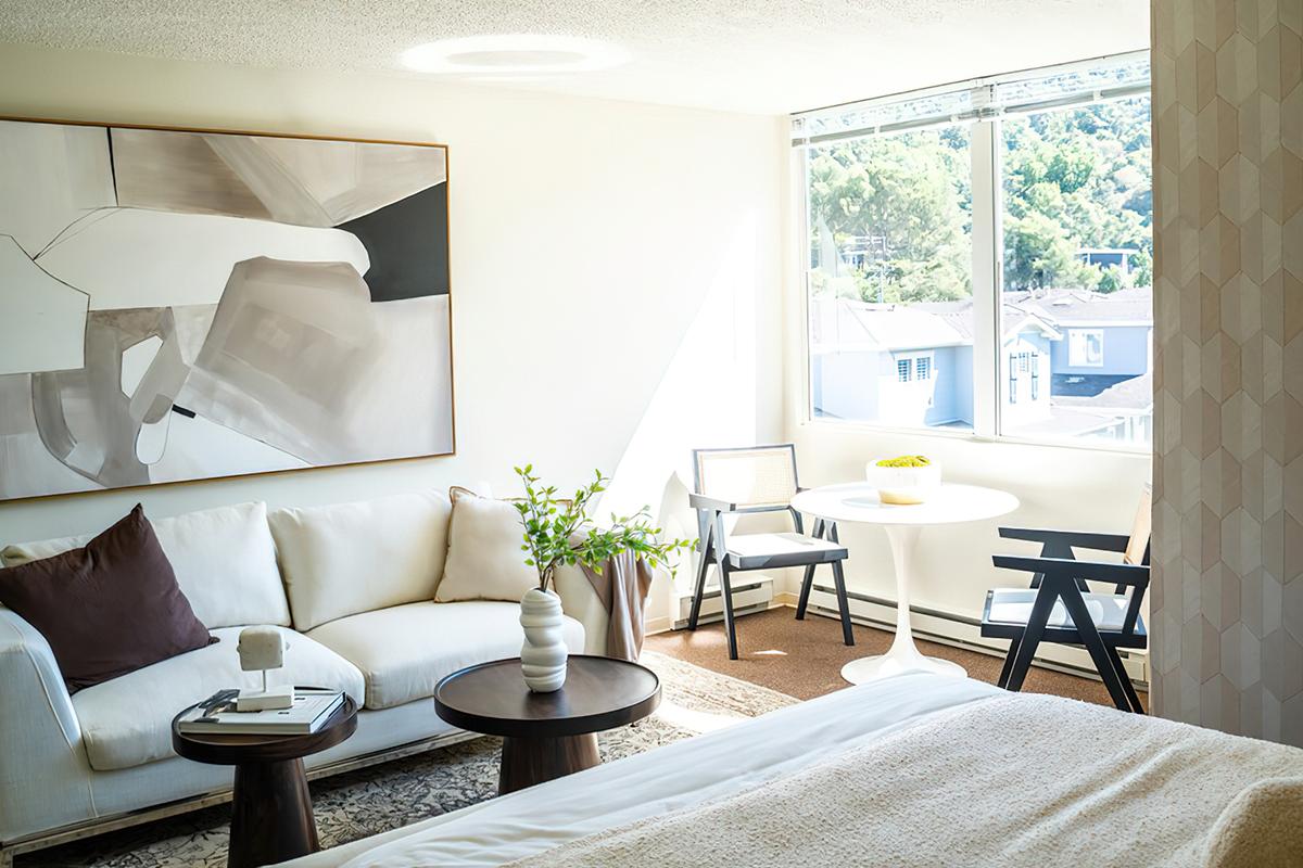 a living room filled with furniture and a large window