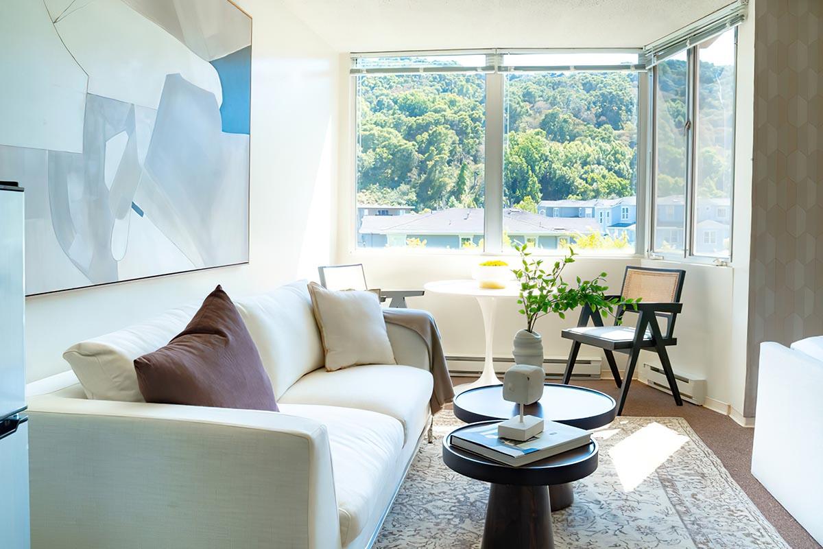 a living room filled with furniture and a large window