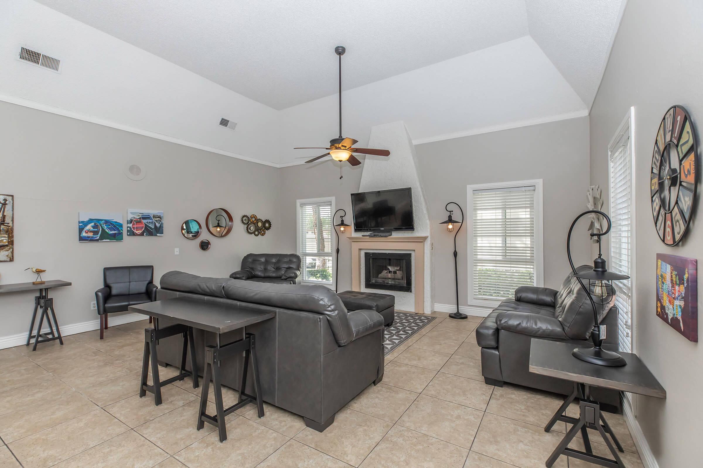 a living area with a desk and chair in a room