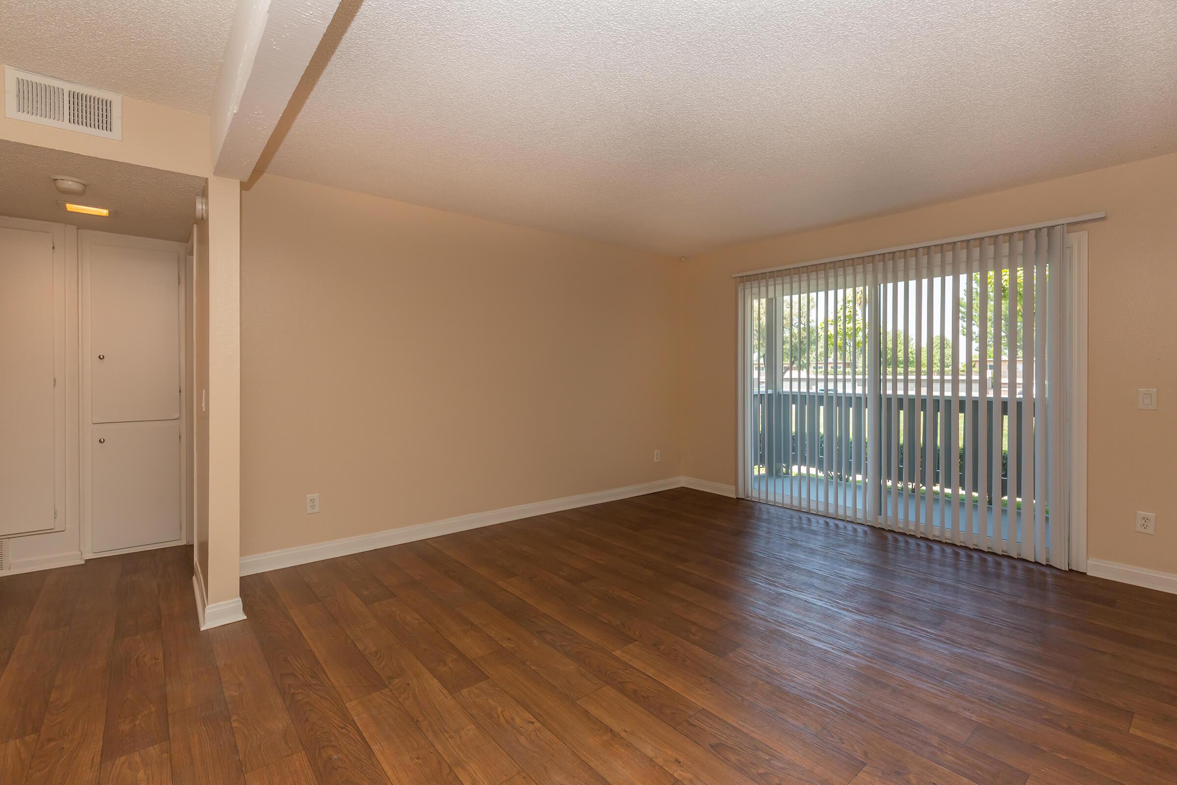 a large empty room with a wood floor