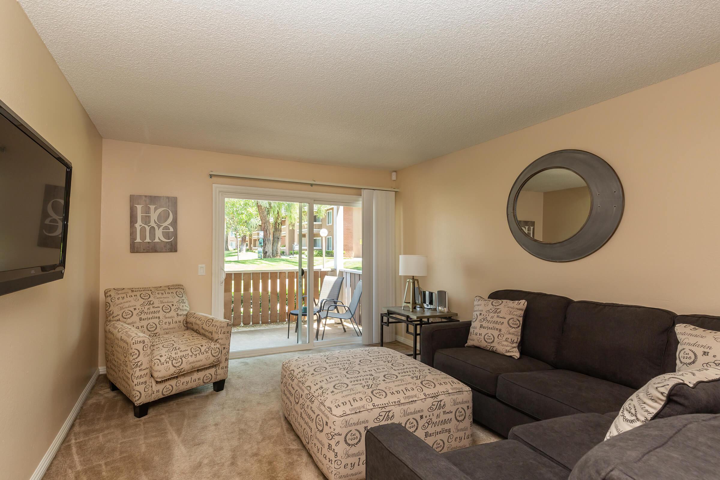 a living room filled with furniture and a flat screen tv