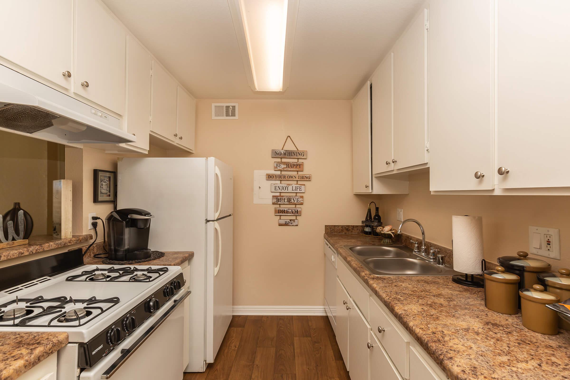 a stove top oven sitting inside of a kitchen