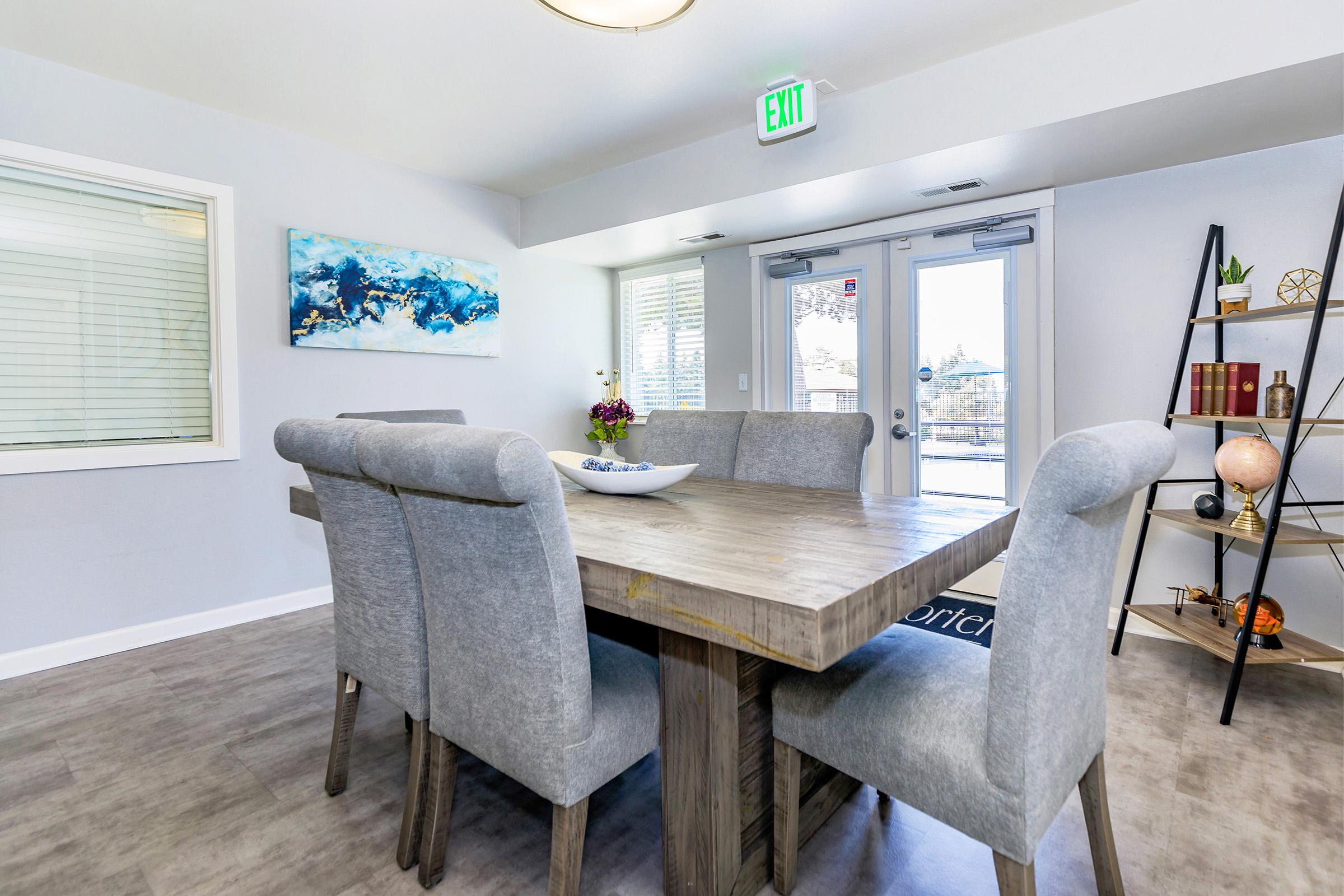 a living room with a desk and chair