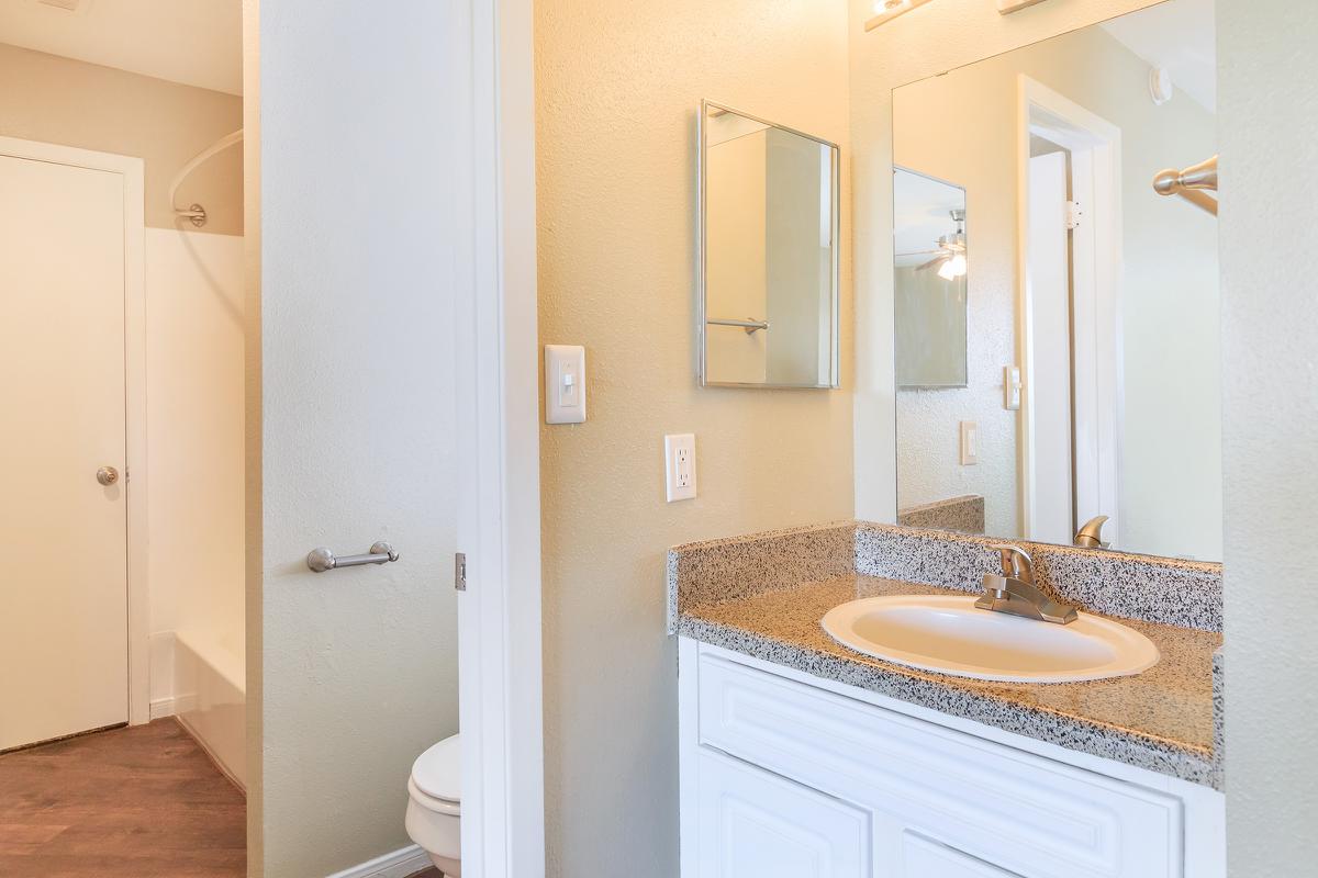 a white sink and a mirror