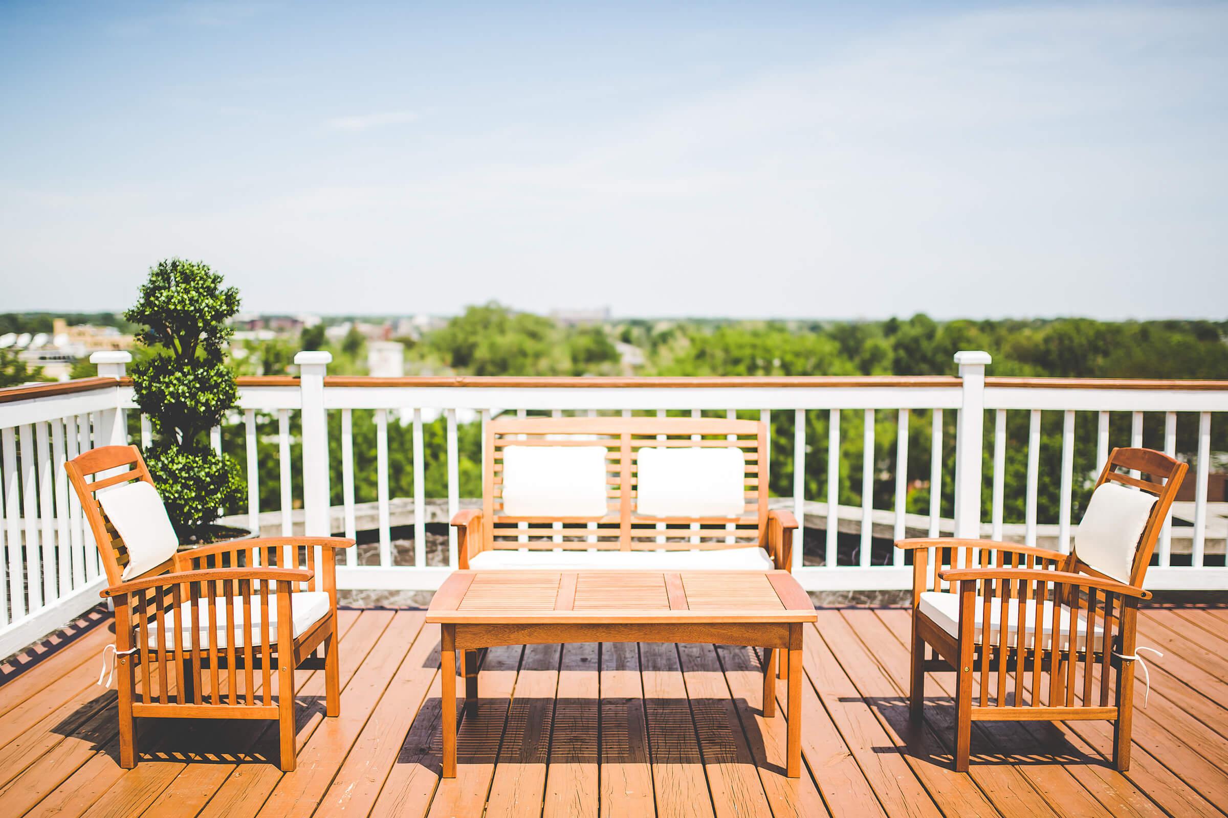 a wooden bench sitting in front of a fence