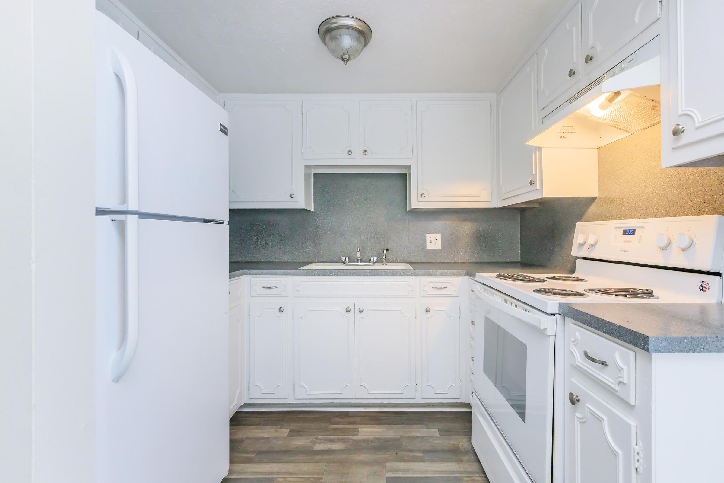 a kitchen with a stove and a refrigerator