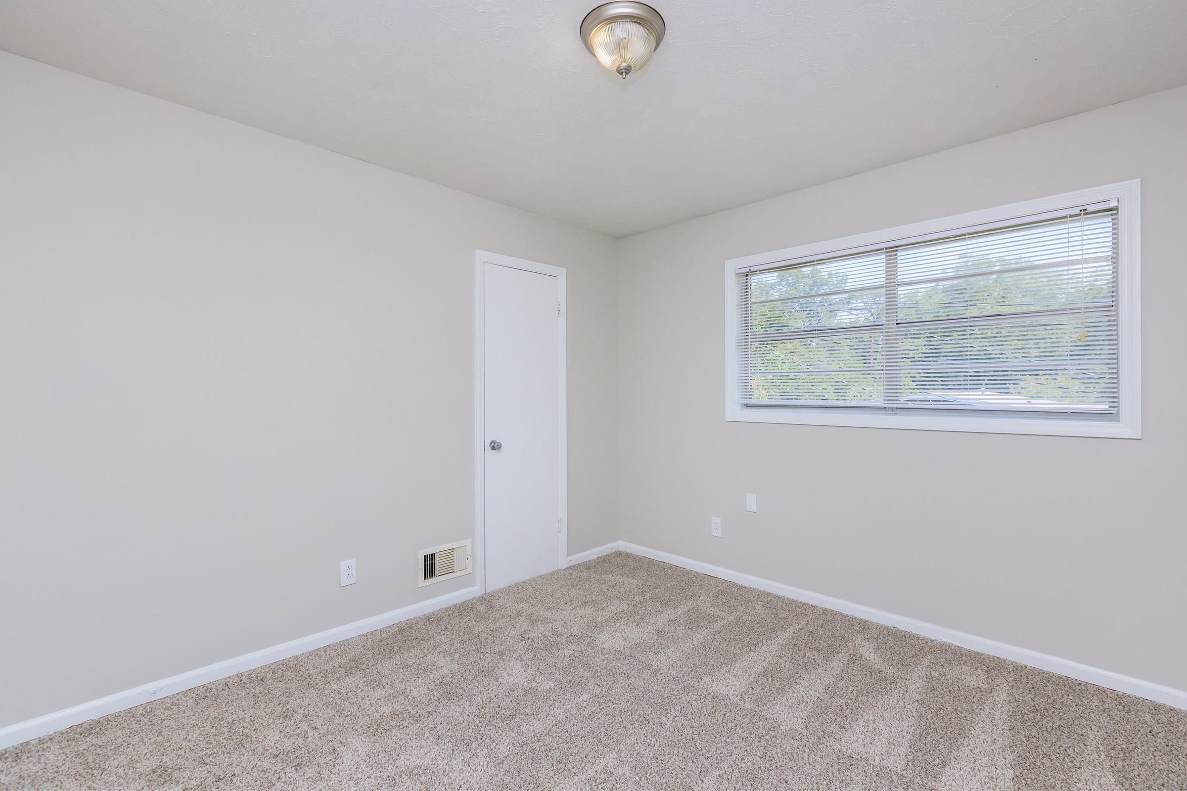 a bedroom with a large window