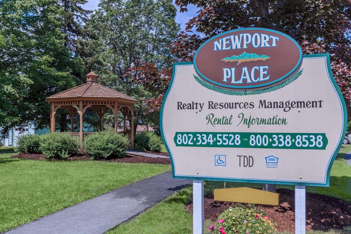 a sign in front of a tree