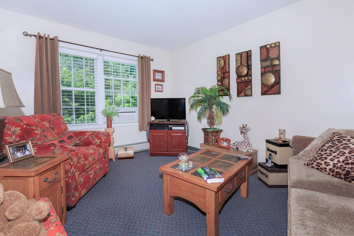 a living room filled with furniture and a large window