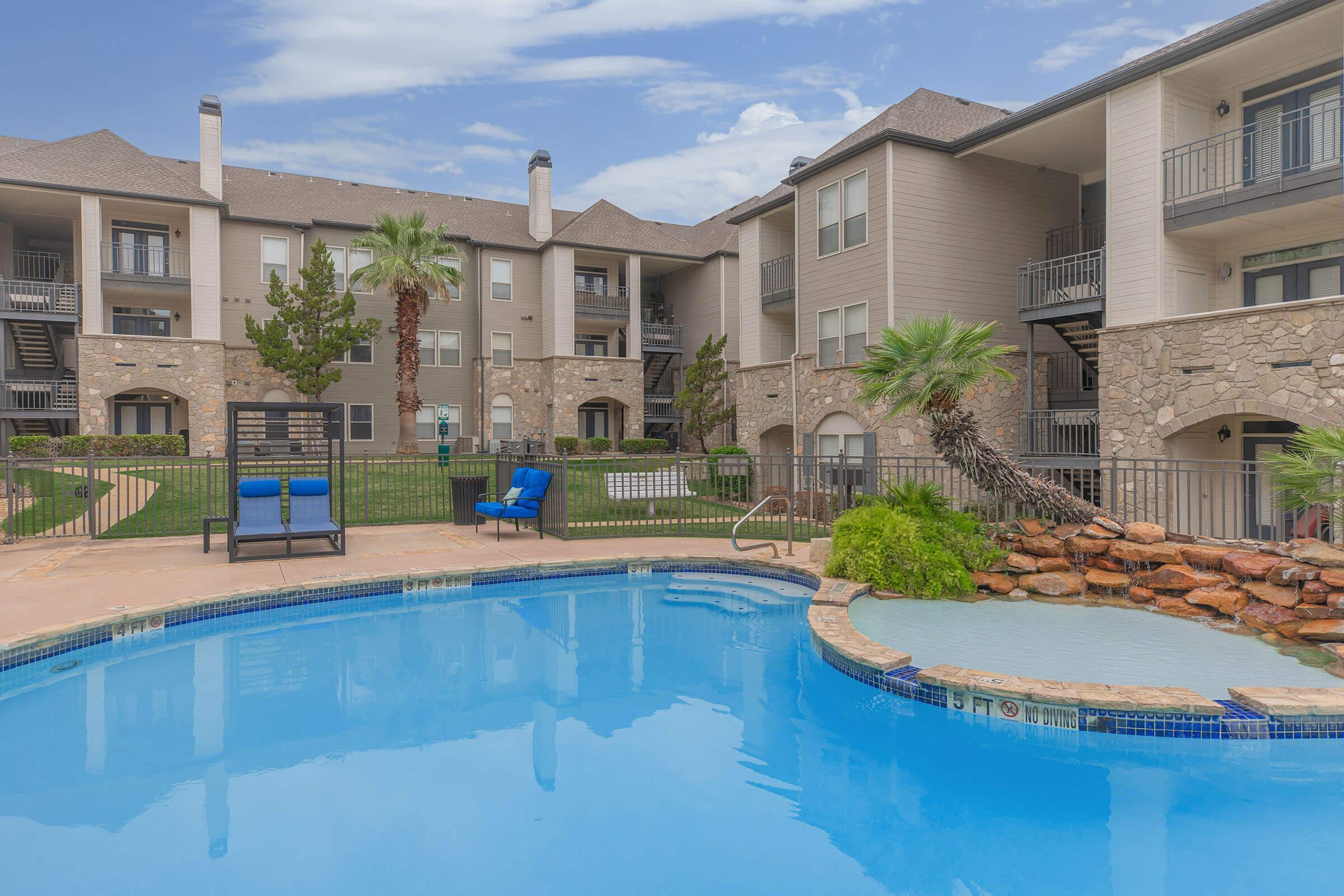 a large pool of water in front of a house