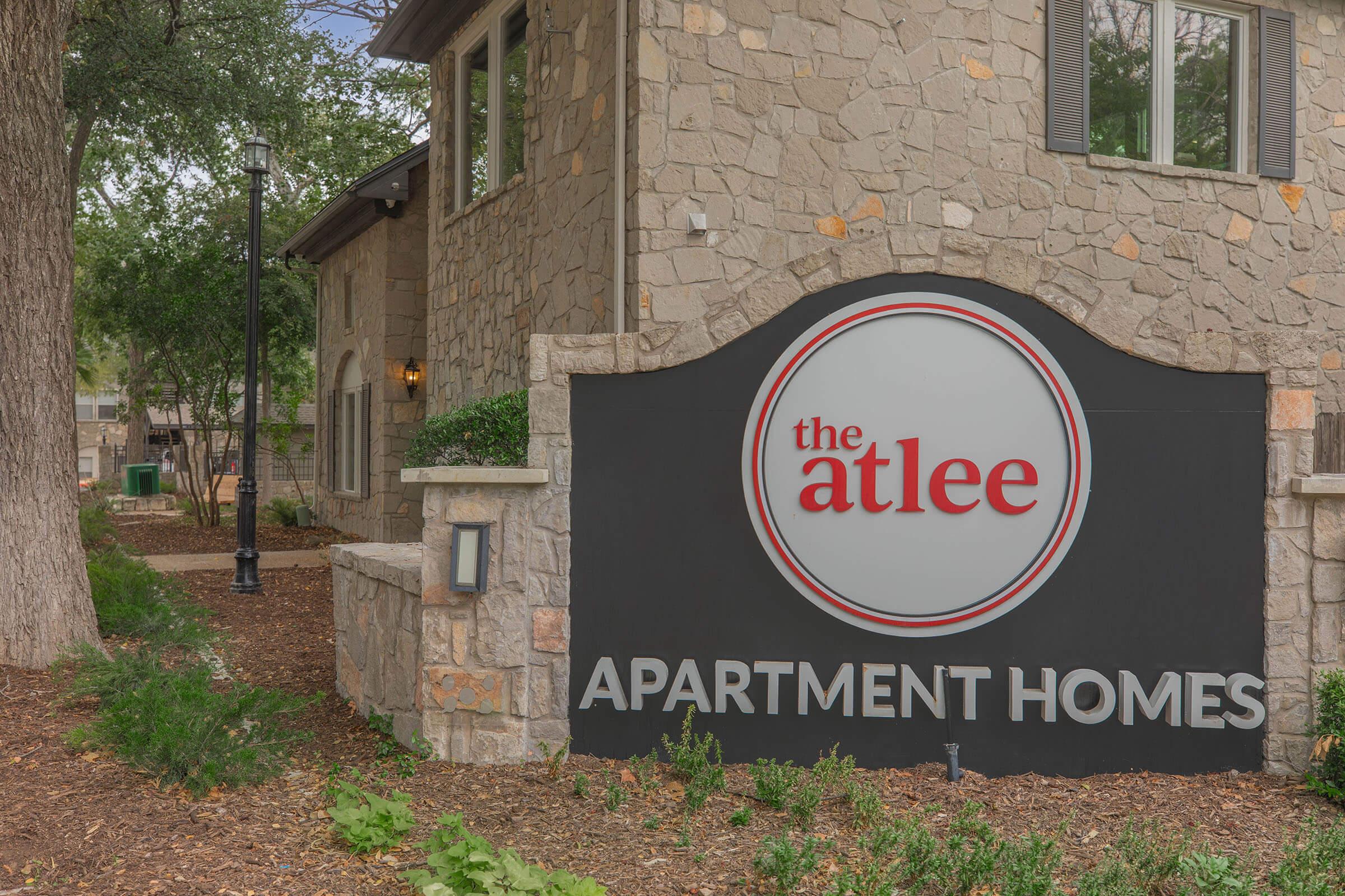 a sign in front of a brick building