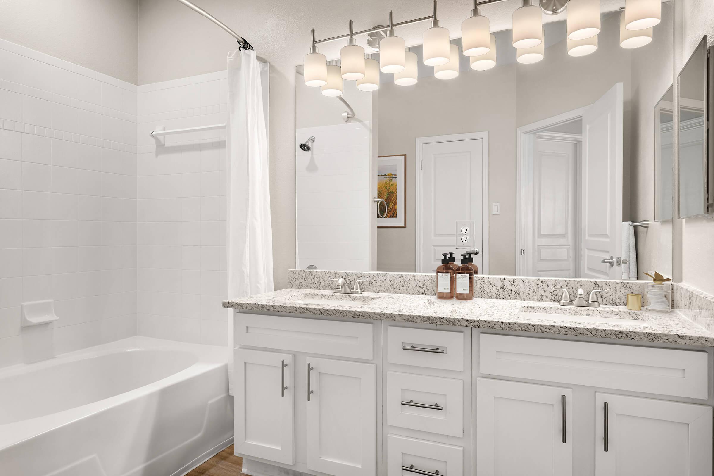 a kitchen with a sink and a mirror