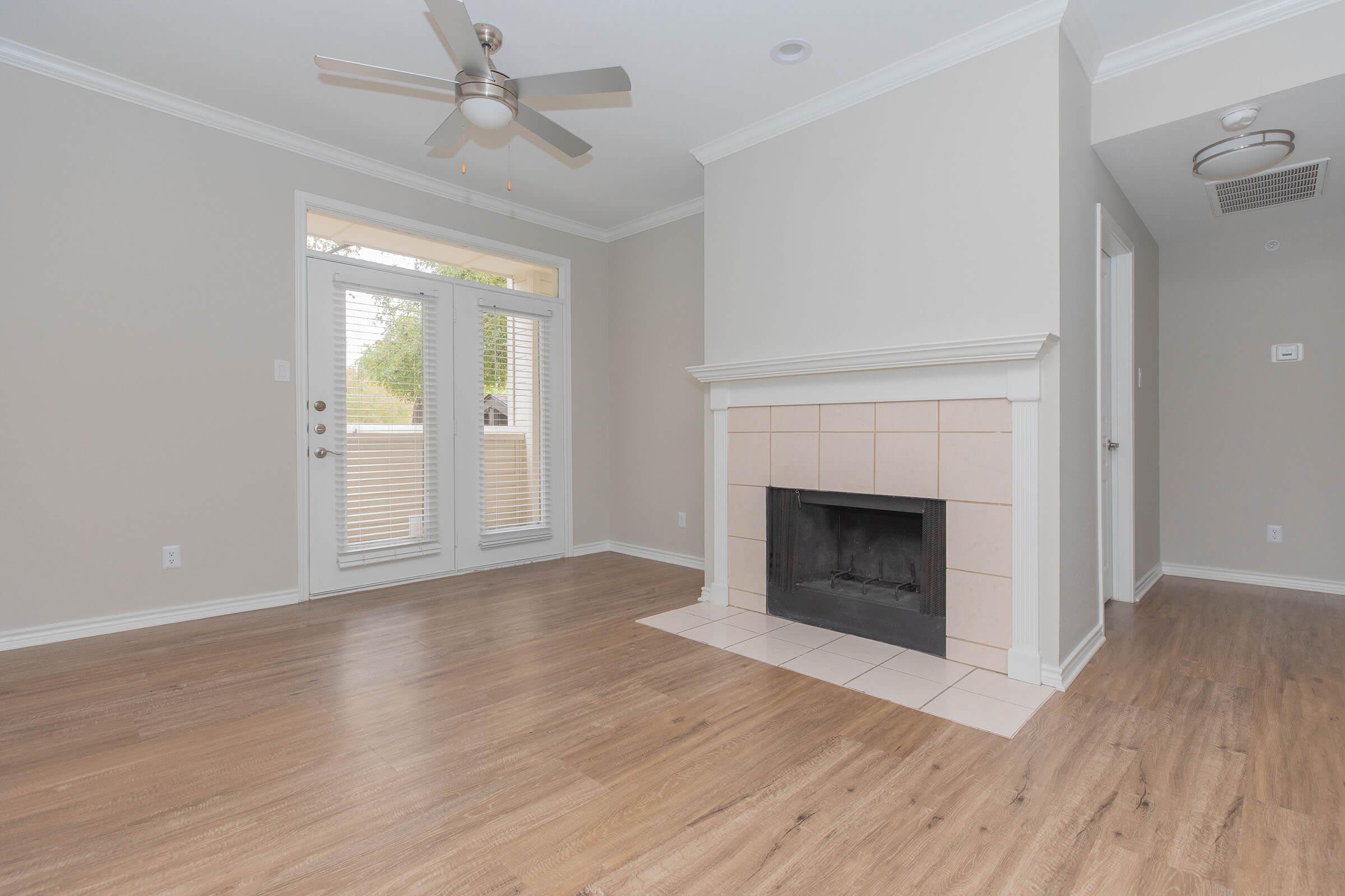 a room with a fireplace and a large window