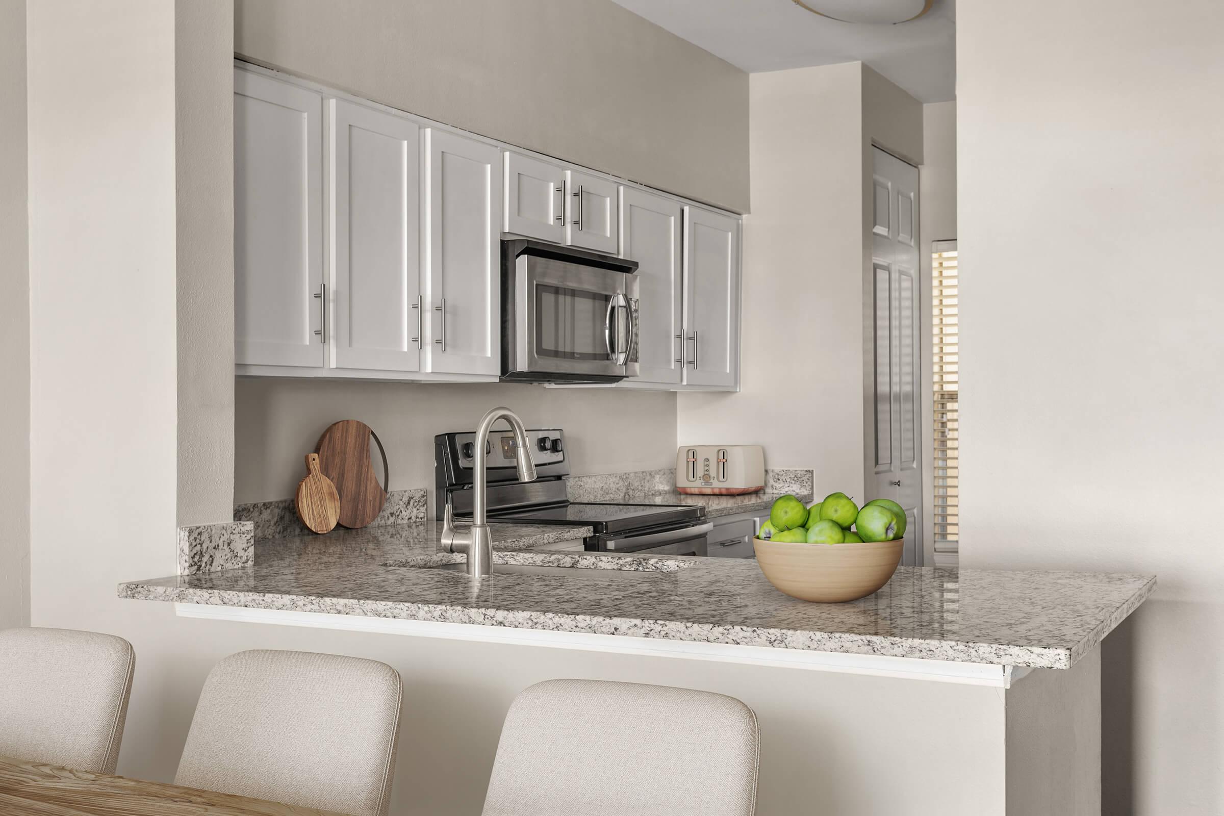 a kitchen with a sink and a mirror