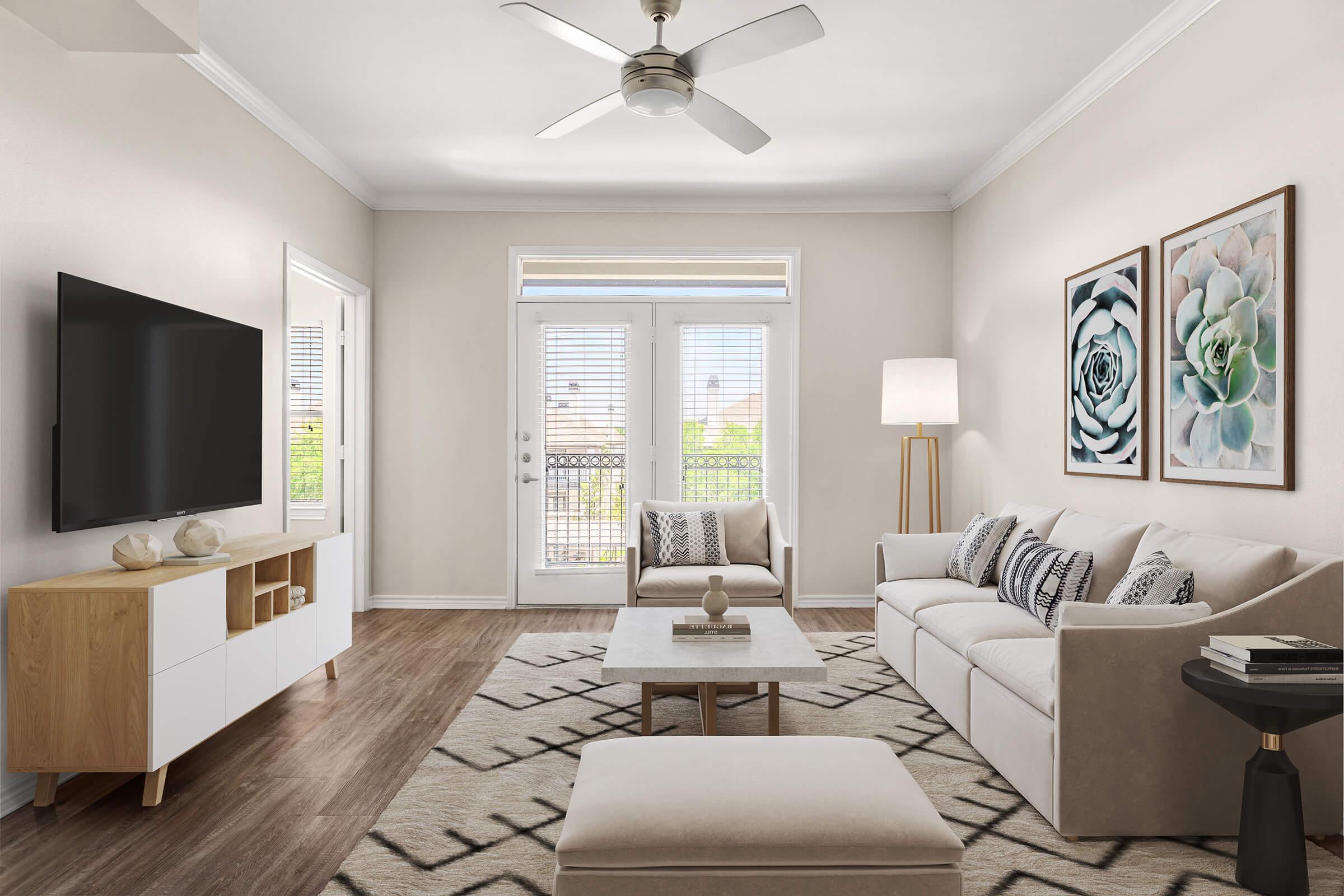 a living room filled with furniture and a large window