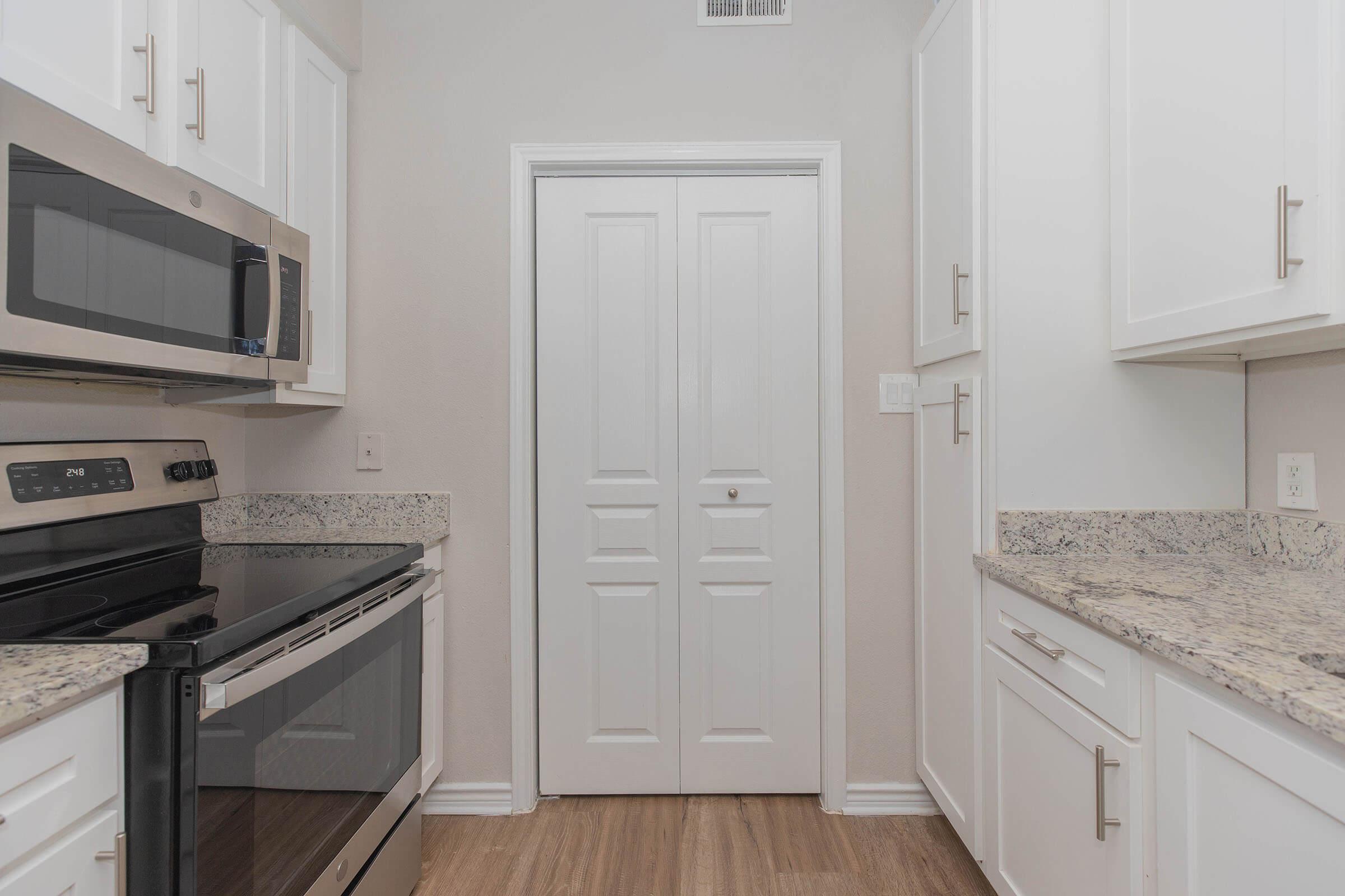 a stove top oven sitting inside of a kitchen