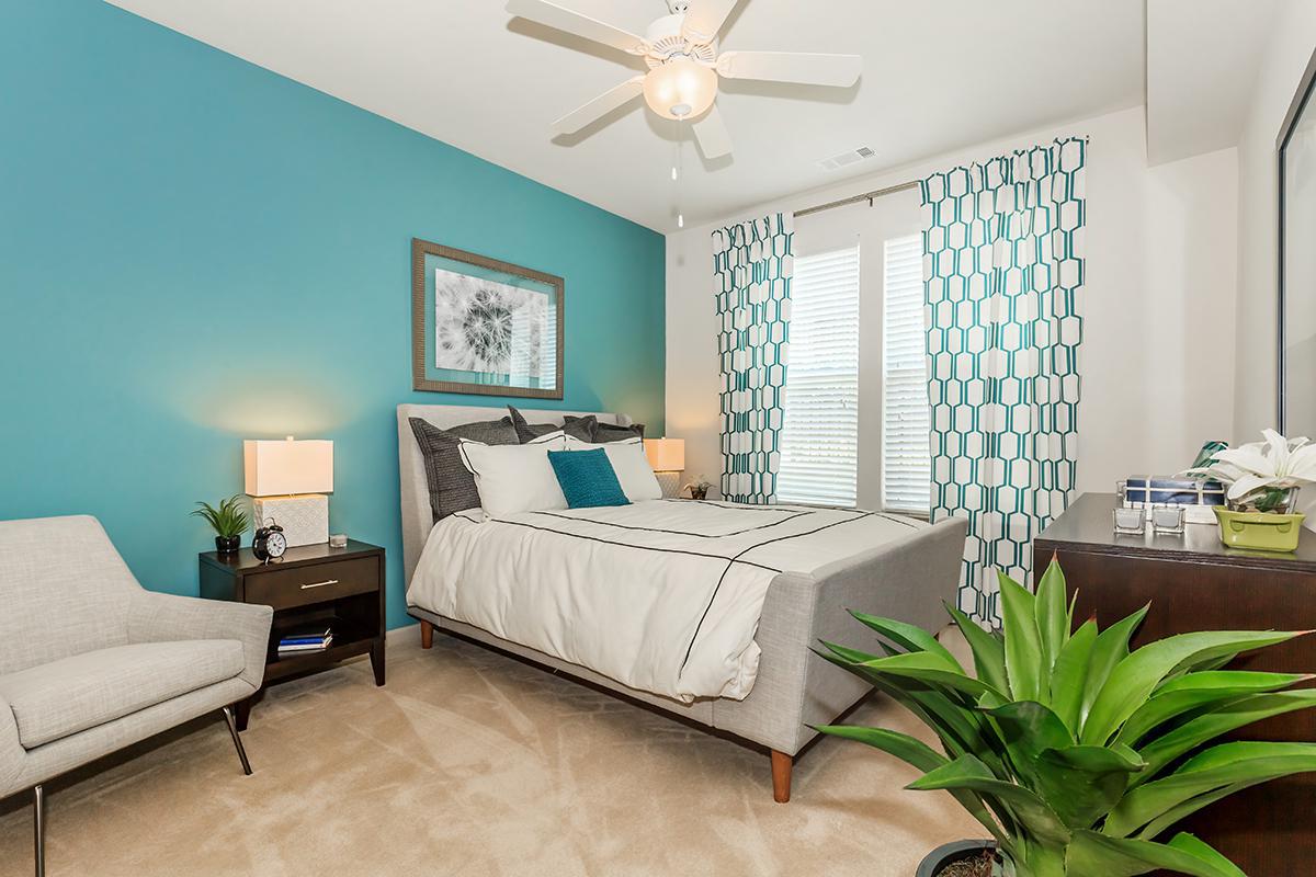 a bedroom with a bed and desk in a room