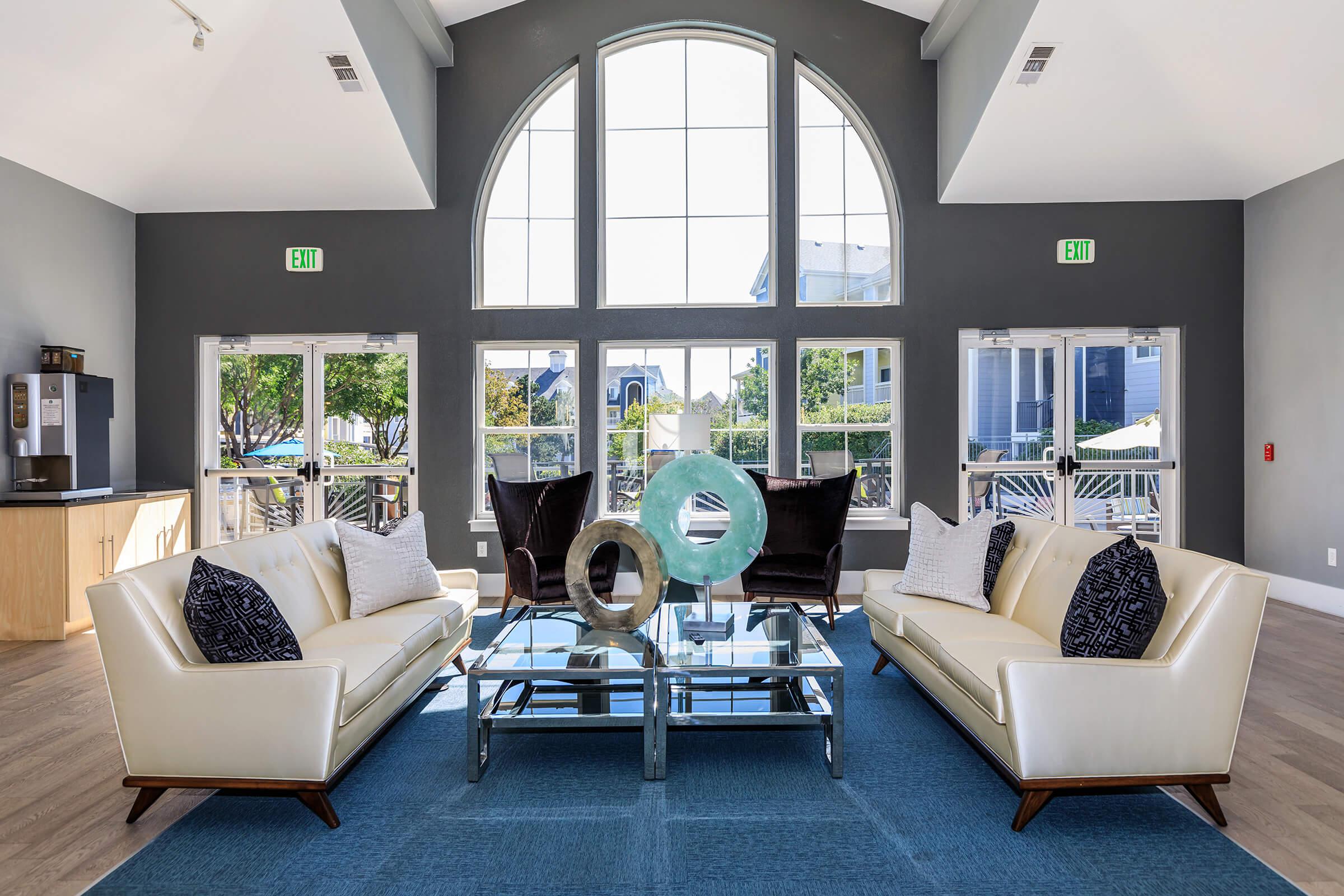 a living room filled with furniture and a large window