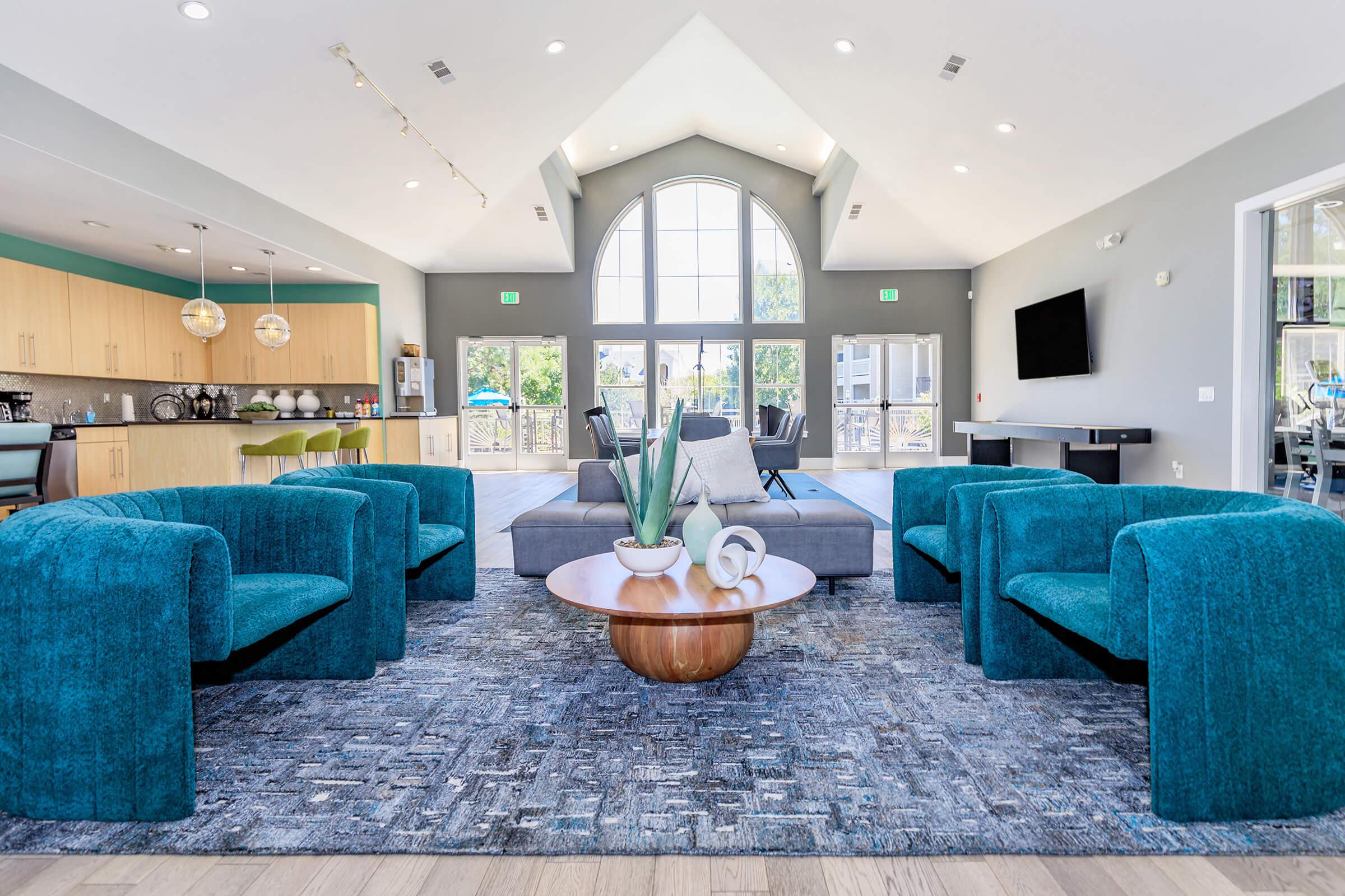 a living room filled with furniture and a blue chair