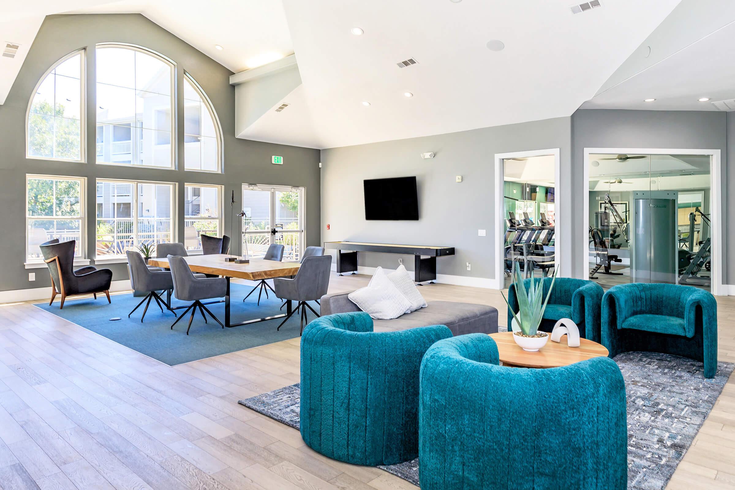 a living room filled with furniture and a large window