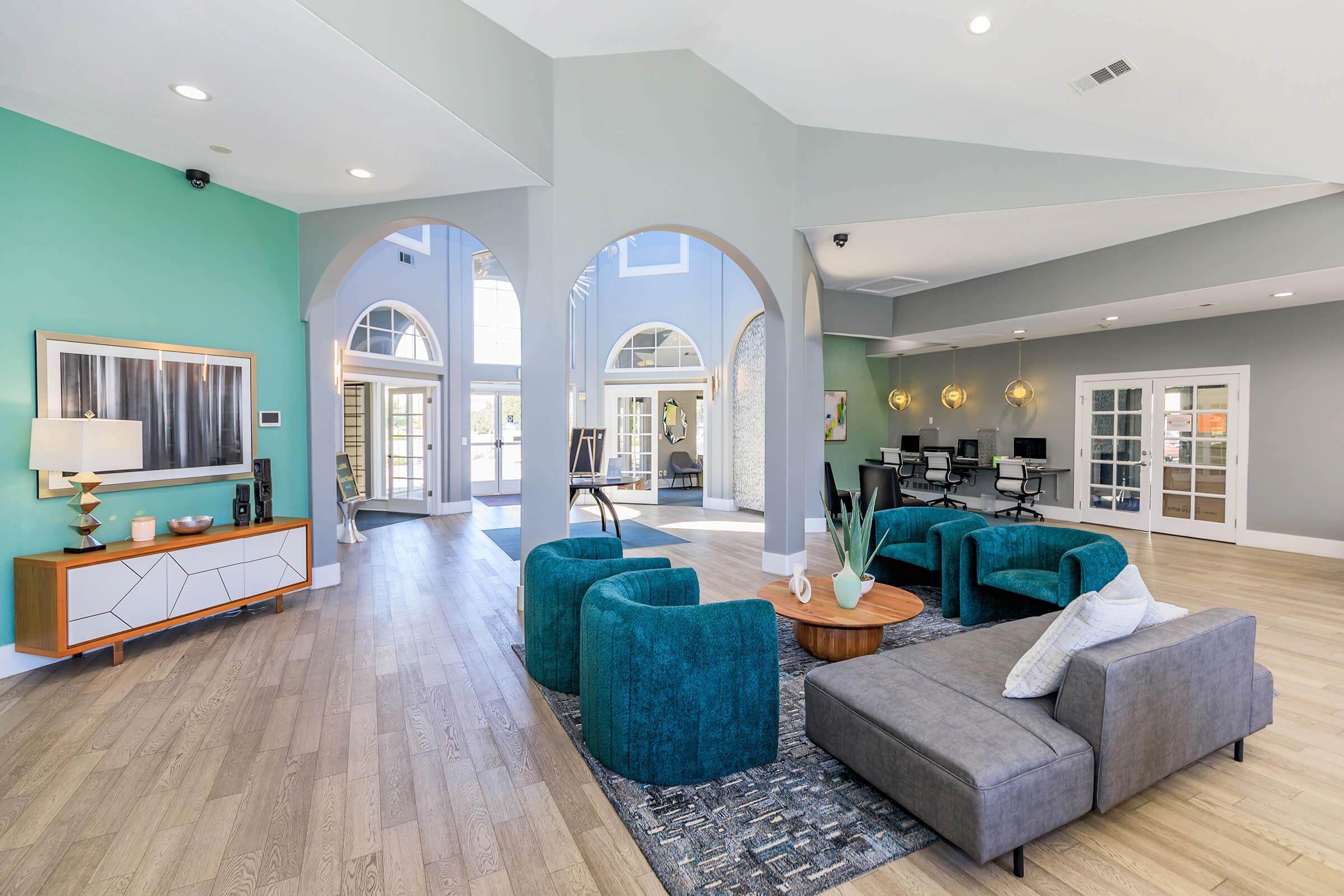 a living room filled with furniture and a large window