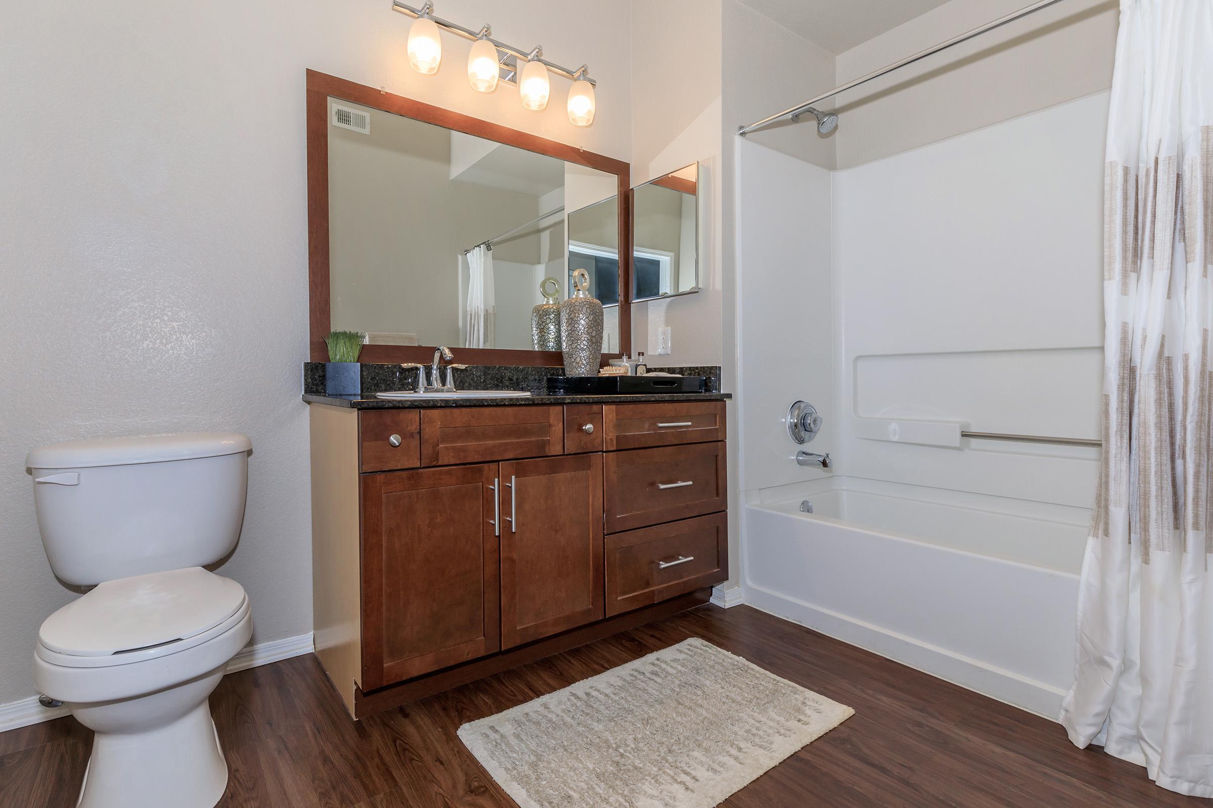 a large white tub next to a shower