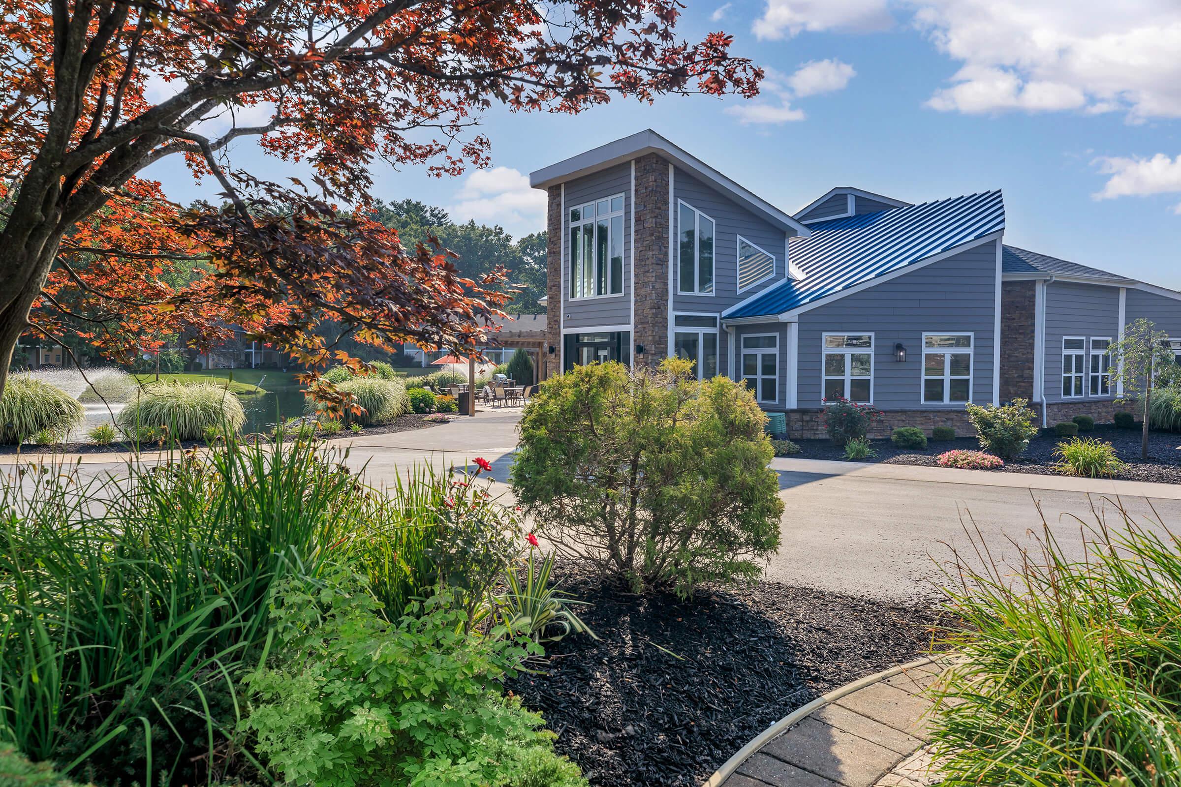 a house with bushes in front of a building