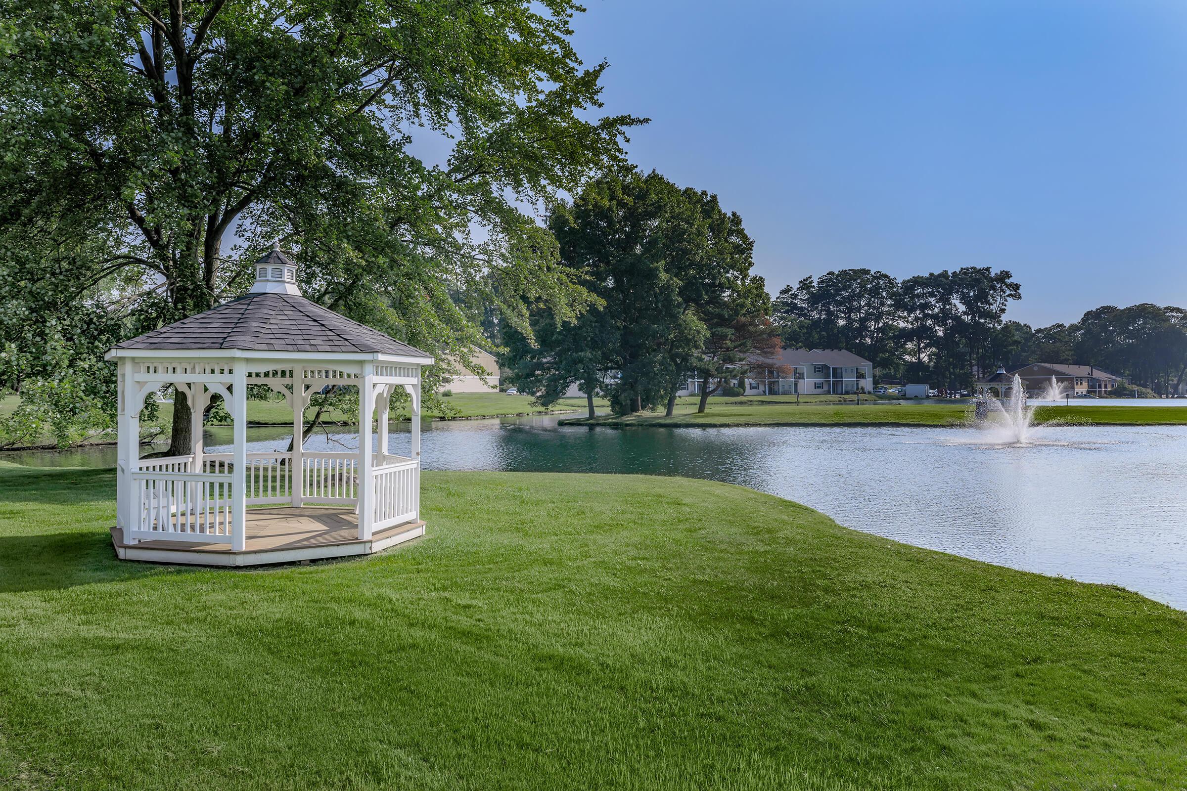 a garden with water in the background