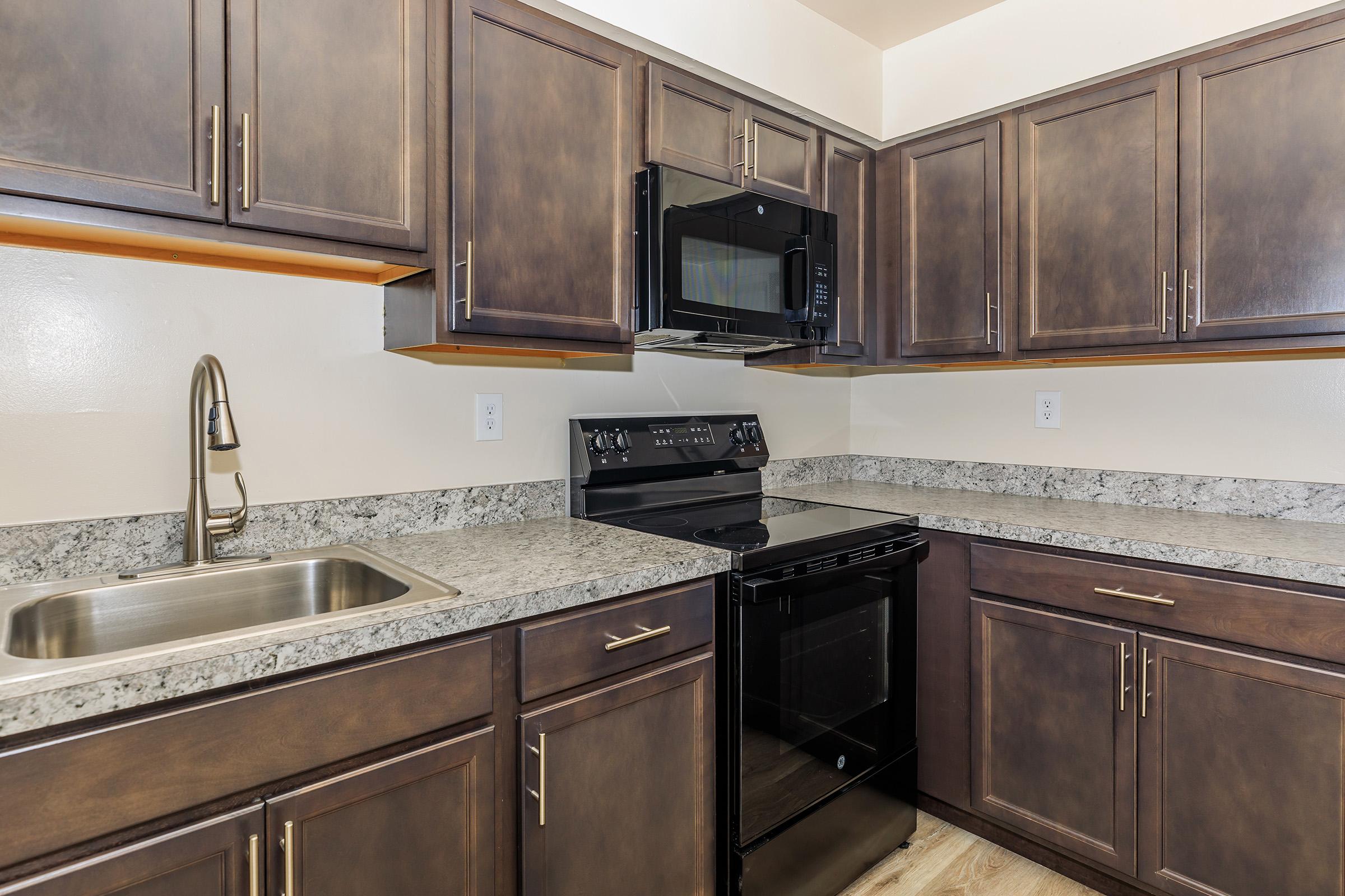 a kitchen with stainless steel appliances and wooden cabinets